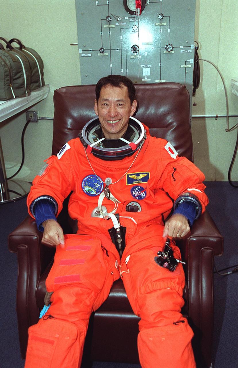 In the Operations and Checkout Building, STS-99 Mission Specialist Mamoru Mohri of Japan smiles as he dons his launch and entry suit during final launch preparations. Known as the Shuttle Radar Topography Mission (SRTM), STS-99 is scheduled for liftoff at 12:30 p.m. EST from Launch Pad 39A. The SRTM will chart a new course to produce unrivaled 3-D images of the Earth's surface. The result of the Shuttle Radar Topography Mission could be close to 1 trillion measurements of the Earth's topography. The mission is expected to last 11days, with Endeavour landing at KSC Tuesday, Feb. 22, at 4:36 p.m. EST. This is the 97th Shuttle flight and 14th for Shuttle Endeavour