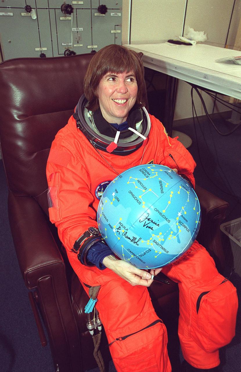In the Operations and Checkout Building, a smiling STS-99 Mission Specialist Janice Voss holds an inflated map globe of the stars after donning her launch and entry suit during final launch preparations. The globe is being signed by the entire crew as a gift for Delores Abraham, with Crew Quarters. STS-99, known as the Shuttle Radar Topography Mission (SRTM), is scheduled for liftoff at 12:30 p.m. EST from Launch Pad 39A. The SRTM will chart a new course to produce unrivaled 3-D images of the Earth's surface. The result of the Shuttle Radar Topography Mission could be close to 1 trillion measurements of the Earth's topography. The mission is expected to last 11days, with Endeavour landing at KSC Tuesday, Feb. 22, at 4:36 p.m. EST. This is the 97th Shuttle flight and 14th for Shuttle Endeavour