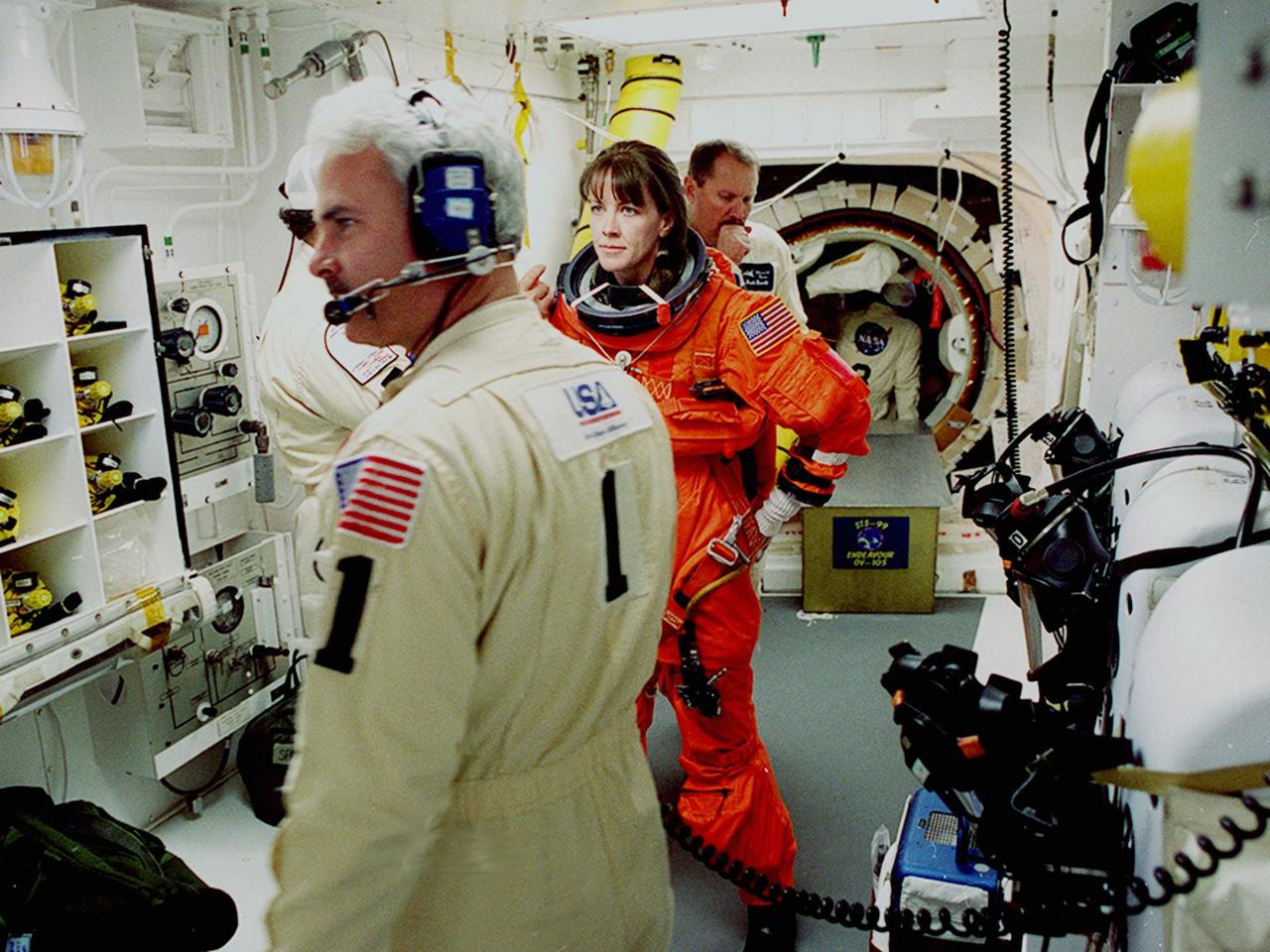 Before entering the orbiter Endeavour, STS-99 Mission Specialist Janet Kavandi is helped with final suit preparations by members of the White Room closeout crew Travis Thompson (hidden), mechanical technician, and Chris Meinert, closeout chief. The White Room is an environmental chamber at the end of the orbiter access arm, on the fixed service structure, that provides entry to the orbiter crew compartment. STS-99, known as the Shuttle Radar Topography Mission (SRTM), will chart a new course to produce unrivaled 3-D images of the Earth's surface. The result of the Shuttle Radar Topography Mission could be close to 1 trillion measurements of the Earth's topography. Scheduled for liftoff at 12:30 p.m. EST, the mission is expected to last 11days, with Endeavour landing at KSC Tuesday, Feb. 22, at 4:36 p.m. EST. This is the 97th Shuttle flight and 14th for Shuttle Endeavour