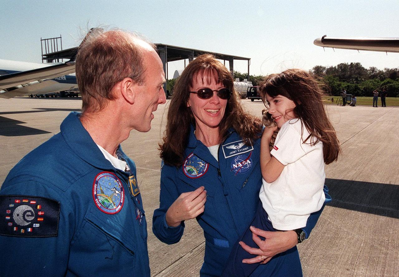 At the Shuttle Landing Facility, STS-99 Mission Specialist Gerhard Thiele (left) joins Mission Specialist Janet Kavandi with her daughter before their departure for Houston. The STS-99 crew completed a successful 11-day Shuttle Radar Topography Mission mapping 47 million square miles of the Earth's surface before landing at KSC Feb. 22