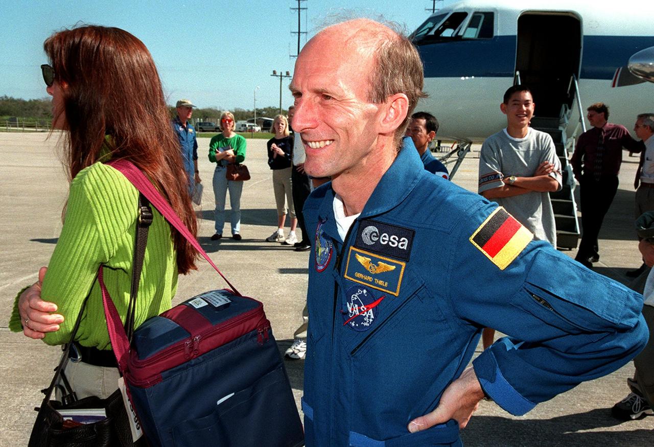 At the Shuttle Landing Facility, STS-99 crew members join family members for their return trip to Houston. At left is Jeanne Kregel, wife of Commander Kevin Kregel. At right is Mission Specialist Gerhard Thiele of Germany. The STS-99 crew completed a successful 11-day Shuttle Radar Topography Mission mapping 47 million square miles of the Earth's surface before landing at KSC Feb. 22