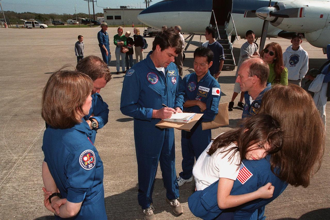 The STS-99 crew get ready to leave KSC with their families for a return trip to Houston. From left are Mission Specialist Janice Voss, Pilot Dominic Gorie, Commander Kevin Kregel, and Mission Specialists Mamoru Mohri of Japan, Gerhard Thiele of Germany, and Janet Kavandi, holding her daughter. The STS-99 crew completed a successful 11-day Shuttle Radar Topography Mission mapping 47 million square miles of the Earth's surface before landing at KSC Feb. 22