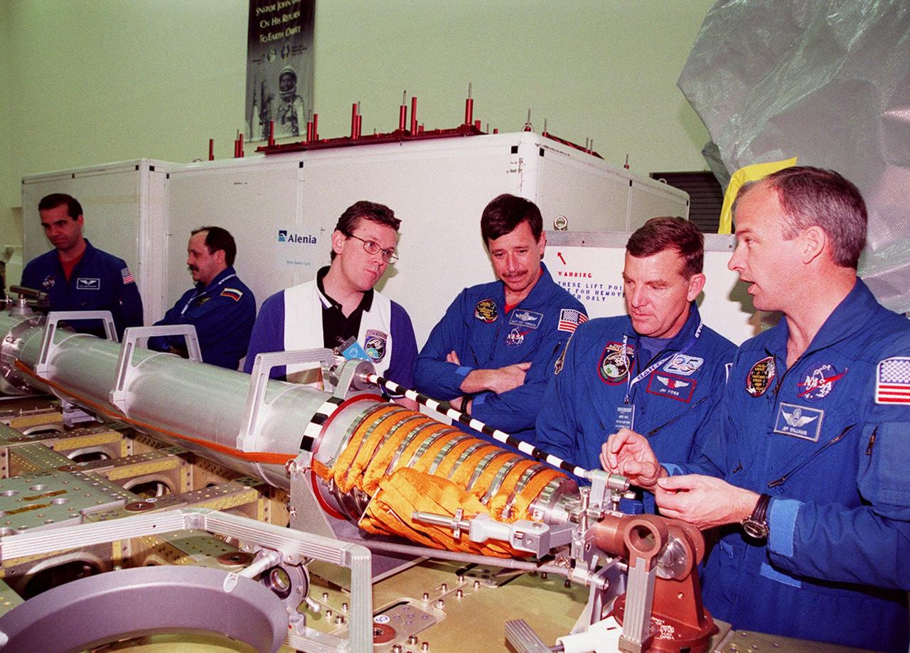 KENNEDY SPACE CENTER, FLA. -- At SPACEHAB, in Cape Canaveral, Fla., members of the STS-101 and STS-106 crew take part in Crew Equipment Interface Test activities, learning about some of the equipment they will be working with, such as the Russian cargo crane Strela in front of them, on their mission to the International Space Station. From left are STS-106 Mission Specialist Richard Mastracchio, Mission Specialist Yuri Usachev of Russia, a SPACEHAB worker, Pilot Scott Horowitz, and Mission Specialists James Voss and Jeffrey Williams. Other STS-101 crew members not shown are Mission Specialists Mary Ellen Weber and Susan Helms. The crew will be responsible for preparing the Space Station for the arrival of the Zvezda Service Module, expected to be launched by Russia in July 2000. Also, the crew will conduct one space walk to perform maintenance on the Space Station and deliver logistics and supplies. This will be the third assembly flight for the Space Station. STS-101 is scheduled to launch no earlier than April 13 from Launch Pad 39A
