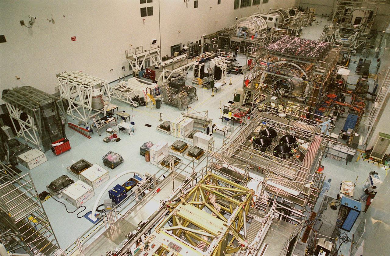 KENNEDY SPACE CENTER, FLA. -- The floor of the Space Station Processing Facility is filled with racks and hardware for testing the various components of the International Space Station (ISS). The large module in the center of the floor (top) is the U.S. Lab, Destiny. Expected to be a major feature in future research, Destiny will provide facilities for biotechnology, fluid physics, combustion, and life sciences research. It is scheduled to be launched on mission STS-98 (no date determined yet for launch). At top left are the Multi-Purpose Logistics Modules Raffaello and Leonardo and the Pressurized Mating Adapter-3 (PMA-3). Italy's major contributions to the ISS program, Raffaello and Leonardo are reusable logistics carriers to resupply and return Station cargo requiring a pressurized environment. They are slated as payloads on missions STS-102 and STS-100, respectively. Dates have not yet been determined for the two missions. The PMA-3, once launched, will be mated to Node 1, a connecting passageway to the living and working areas of the Space Station. The primary purpose of PMA-3 is to serve as a Shuttle docking port through which crew members and equipment will transfer to the Space Station during later assembly missions. PMA-3 is scheduled as payload on mission STS-92, whose date for launch is not yet determined