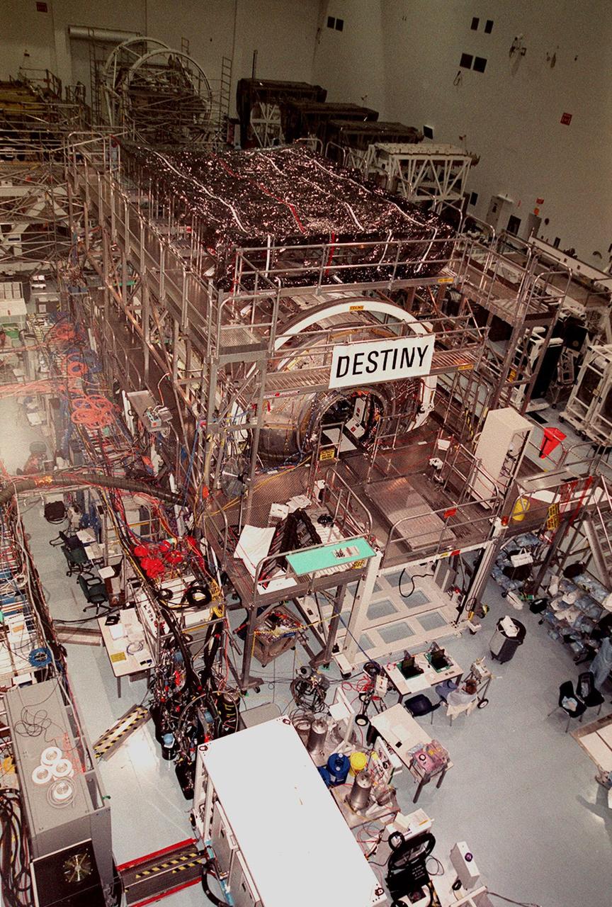 KENNEDY SPACE CENTER, FLA. -- The U.S. Lab Destiny dominates the center of the Space Station Processing Facility (SSPF), which is filled with other hardware and equipment for the International Space Station. Elsewhere in the SSPF are also the Multi-Purpose Logistics Modules Raffaello and Leonardo and the Pressurized Mating Adapter-3 (PMA-3). The PMA-3 is the first element scheduled to be launched to the Space Station, on STS-92. Next is Destiny, on STS-98, followed by the MPLMs on STS-102 and STS-100. No dates have been determined yet for these missions