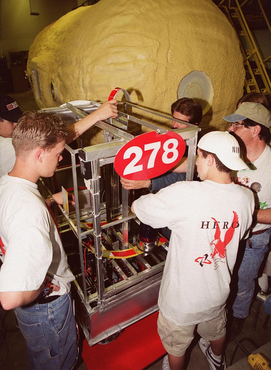 The Hero Team (278) gets some help from a Kennedy Space Center research and development machine shop in repairing their robot, named Hero. The team of Edgewater High School students was co-sponsored by NASA Kennedy Space Center and Honeywell. Students from all over the country are at the KSC Visitor Complex for the FIRST (For Inspiration and Recognition of Science and Technology) Southeast Regional competition March 9-11 in the Rocket Garden. Teams of high school students are testing the limits of their imagination using robots they have designed, with the support of business and engineering professionals and corporate sponsors, to compete in a technological battle against other schools' robots. Of the 30 high school teams competing, 16 are Florida teams co-sponsored by NASA and KSC contractors. Local high schools participating are Astronaut, Bayside, Cocoa Beach, Eau Gallie, Melbourne, Melbourne Central Catholic, Palm Bay, Rockledge, Satellite, and Titusville