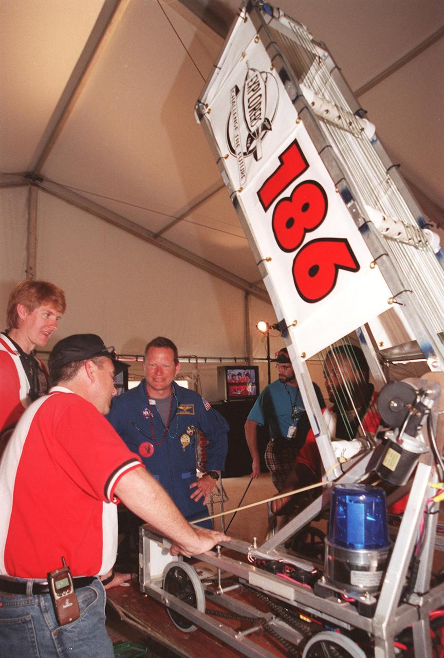 Astronaut David Brown chats with members of the Explorers team, from Lake Buena Vista, Fla., during the FIRST (For Inspiration and Recognition of Science and Technology) Southeast Regional competition held March 9-11 in the KSC Visitor Complex Rocket Garden. Teams of high school students from all over the country are testing the limits of their imagination using robots they have designed, with the support of business and engineering professionals and corporate sponsors, to compete in a technological battle against other schools' robots. Of the 30 high school teams competing at the Southeast Regional event, 16 are Florida teams co-sponsored by NASA and KSC contractors. Local high schools participating are Astronaut, Bayside, Cocoa Beach, Eau Gallie, Melbourne, Melbourne Central Catholic, Palm Bay, Rockledge, Satellite, and Titusville