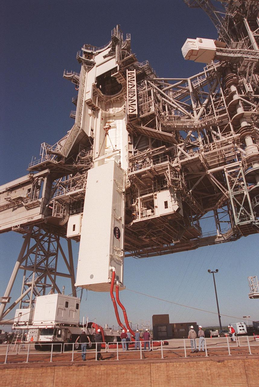 KENNEDY SPACE CENTER, FLA. -- At Launch Pad 39A, the payload canister with the SPACEHAB Double Module and Integrated Cargo Carrier (ICC) inside is lifted up the Rotating Service Structure toward the Payload Changeout Room, an environmentally controlled facility supporting cargo delivery to the pad and vertical installation in the orbiter cargo bay. The primary payloads on mission STS-101, the module and ICC contain internal logistics and resupply cargo for restoring full redundancy to the International Space Station power system in preparation for the arrival of the next pressurized module, the Russian-built Zvezda. The payloads will be transferred to Space Shuttle Atlantis after Atlantis rolls out to the pad. Launch of Atlantis on mission STS-101 is scheduled no earlier than April 17, 2000