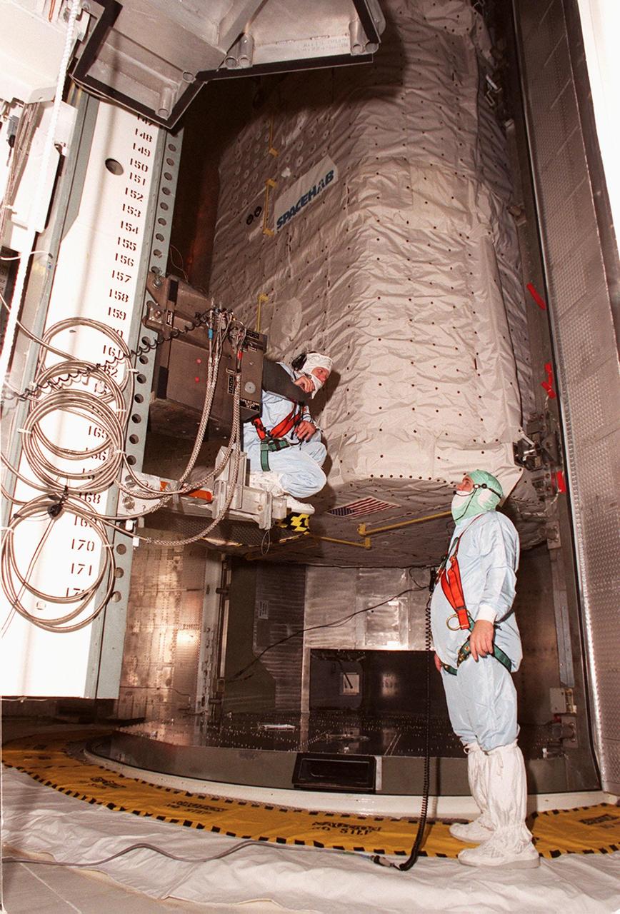 KENNEDY SPACE CENTER, FLA. -- Workers in the Payload Changeout Room (PCR) at Launch Pad 39A check out the SPACEHAB Double Module before moving into the PCR. Part of the Rotating Service Structure, the PCR is an environmentally controlled facility supporting cargo delivery to the pad and vertical installation in the orbiter cargo bay. The primary payloads on mission STS-101, the module and ICC contain internal logistics and resupply cargo for restoring full redundancy to the International Space Station power system in preparation for the arrival of the next pressurized module, the Russian-built Zvezda. The payloads will be transferred to Space Shuttle Atlantis after Atlantis rolls out to the pad. Launch of Atlantis on mission STS-101 is scheduled no earlier than April 17, 2000