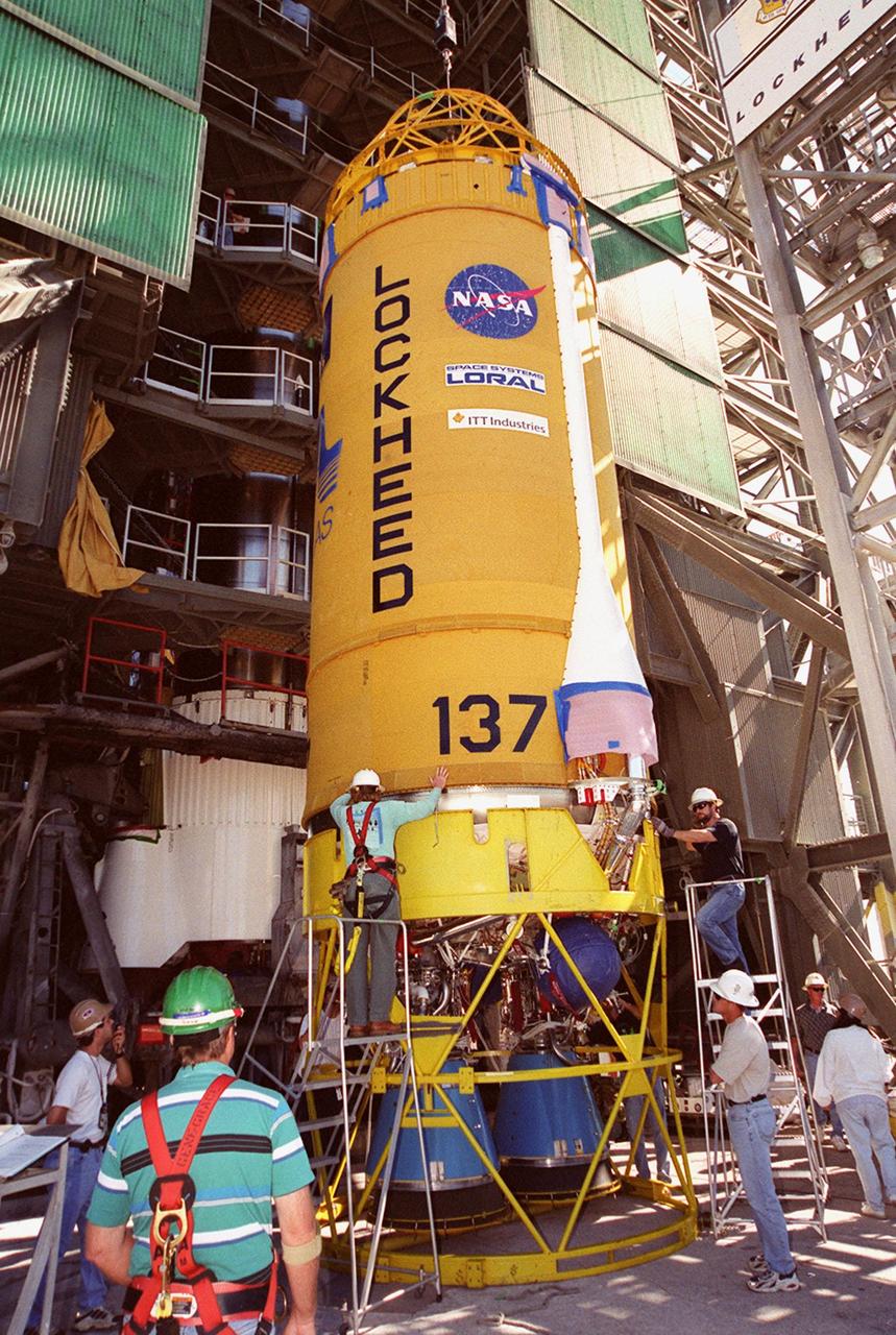 At launch pad 36-A, Cape Canaveral Air Force Station, workers check over the second stage of an Atlas II/Centaur rocket before it is lifted up the gantry (behind it) for mating with the first stage. Atlas II is designed to launch payloads into low earth orbit, geosynchronous transfer orbit or geosynchronous orbit. The rocket is the launch vehicle for the GOES-L satellite, part of the NOAA National Weather Service system in weather imagery and atmospheric sounding information. The primary objective of the GOES-L is to provide a full capability satellite in an on-orbit storage condition, to assure NOAA continuity in services from a two-satellite constellation. Launch services are being provided by the 45th Space Wing