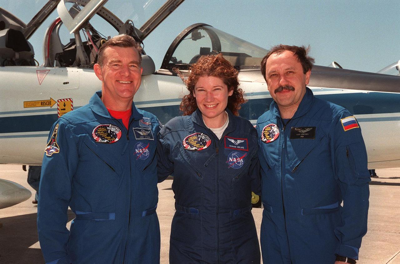 KENNEDY SPACE CENTER, FLA. -- Posing on the tarmac at the Shuttle Landing Facility after their arrival aboard T-38 jets (in the background) are STS-101 Mission Specialists James Voss, Susan Helms and Yury Usachev. They and the rest of the crew are at KSC to take part in Terminal Countdown Demonstration Test (TCDT) activities that include emergency egress training and a dress rehearsal for launch. The other crew members are Commander James Halsell, Pilot Scott Horowitz, and Mission Specialists Mary Ellen Weber and Jeffrey Williams. During their mission to the International Space Station, the STS-101 crew will be delivering logistics and supplies, plus preparing the Station for the arrival of the Zvezda Service Module, expected to be launched by Russia in July 2000. Also, the crew will conduct one space walk to perform maintenance on the Space Station. This will be the third assembly flight for the Space Station. STS-101 is scheduled to launch April 24 at 4:15 p.m. from Launch Pad 39A