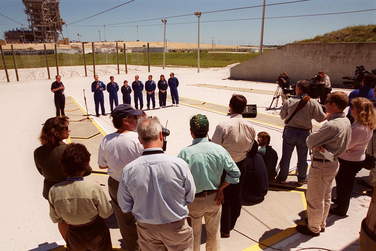 KENNEDY SPACE CENTER, Fla.  -- After Terminal Countdown Demonstration Test (TCDT) activities at Launch Pad 39A, the STS-101 crew answer questions from the media. Standing in the background (left to right) are moderator George Diller, with NASA Public Affairs; Commander James D. Halsell Jr., with the microphone; Pilot Scott J. "Doc" Horowitz; and Mission Specialists Mary Ellen Weber, Jeffrey N. Williams, James Voss, Susan J. Helms and Yuri Usachev of Russia. The TCDT includes emergency egress training and a simulated launch countdown. During their mission to the International Space Station, the STS-101 crew will be delivering logistics and supplies, plus preparing the Station for the arrival of the Zvezda Service Module, expected to be launched by Russia in July 2000. Also, the crew will conduct one space walk to perform maintenance on the Space Station. This will be the third assembly flight for the Space Station. STS-101 is scheduled to launch April 24 at 4:15 p.m. from Launch Pad 39A