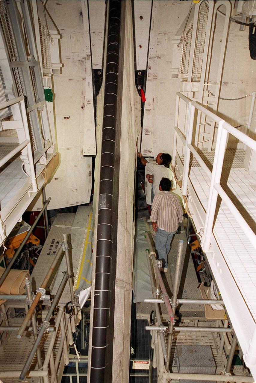 KENNEDY SPACE CENTER, FLA. -- United Space Alliance technicians at Launch Pad 39A look at the site of the power drive unit (PDU) for the rudder/speed brake on Shuttle Atlantis. From left are Mark Noel, Tod Biddle and Bob Wright. Shuttle managers decided to replace the faulty PDU, about the size of an office copy machine, at the launch pad. If successful, launch preparations will continue as planned, with liftoff targeted for April 24 at 4:15 p.m. on mission STS-101. The mission is the third assembly flight for the International Space Station, carrying logistics and supplies to the Space Station, plus the crew will be preparing the Station for the arrival of the Zvezda Service Module, expected to be launched by Russia in July 2000. The crew will conduct one space walk to perform maintenance on the Space Station