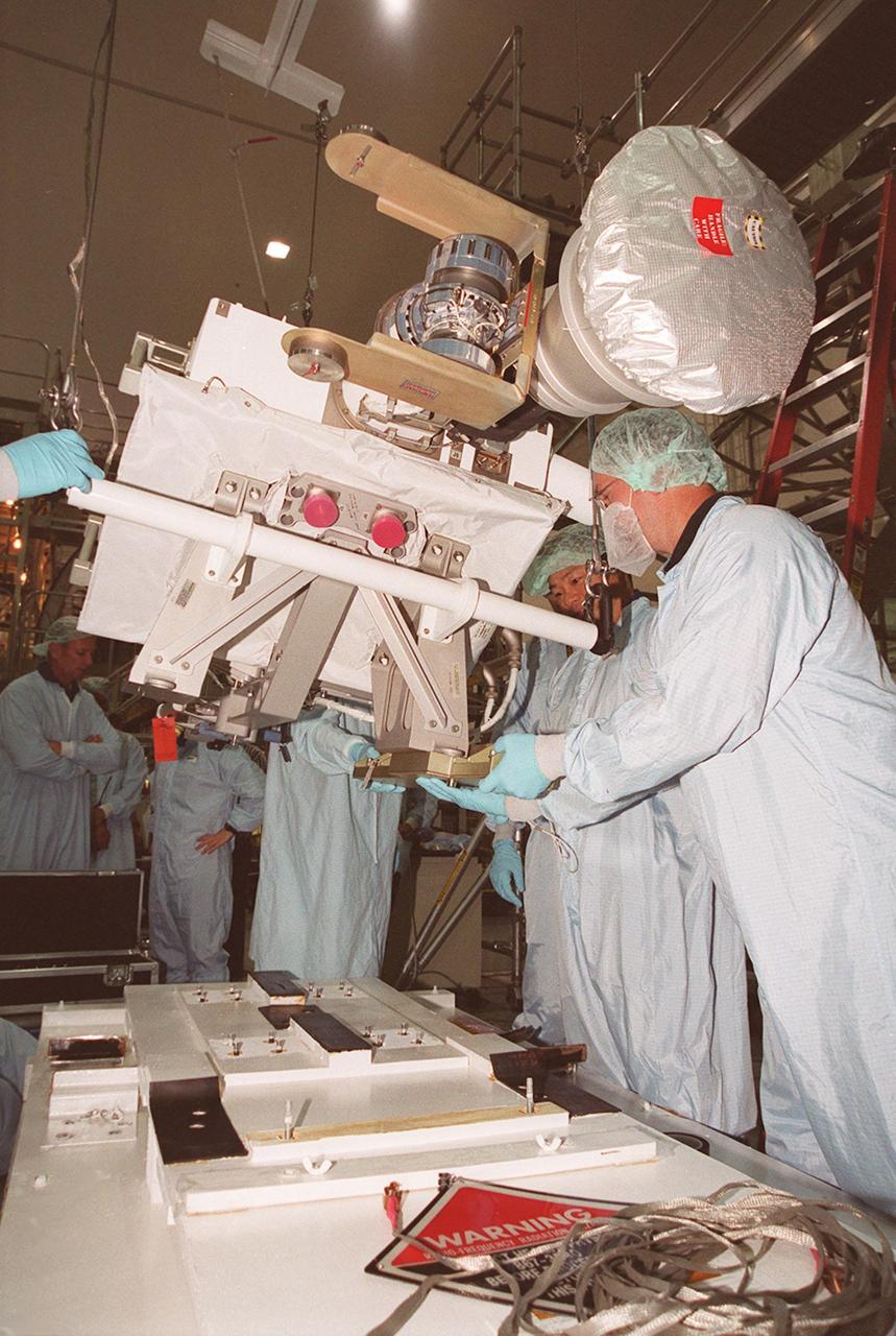 KENNEDY SPACE CENTER, FLA. -- In the Space Station Processing Facility, members of the STS-92 crew examine equipment that will be part of their mission to the International Space Station (ISS). The fourth U.S. flight to the ISS, the mission payload includes the Integrated Truss Structure Z1, an early exterior framework to allow the first U.S. solar arrays on a future flight to be temporarily installed on Unity for early power; Ku-band communication to support early science capability and U.S. television; and PMA-3 to provide a Shuttle docking port for solar array installation on the sixth ISS flight and Lab installation on the seventh ISS flight. The crew comprises Mission Commander Brian Duffy, Pilot Pamela Melroy, and Mission Specialists Koichi Wakata, Leroy Chiao, Peter "Jeff" Wisoff, Michael Lopez-Alegria, and William McArthur. Launch of STS-92 is scheduled for Sept. 21, 2000. Wakata is with the National Space Development Agency of Japan