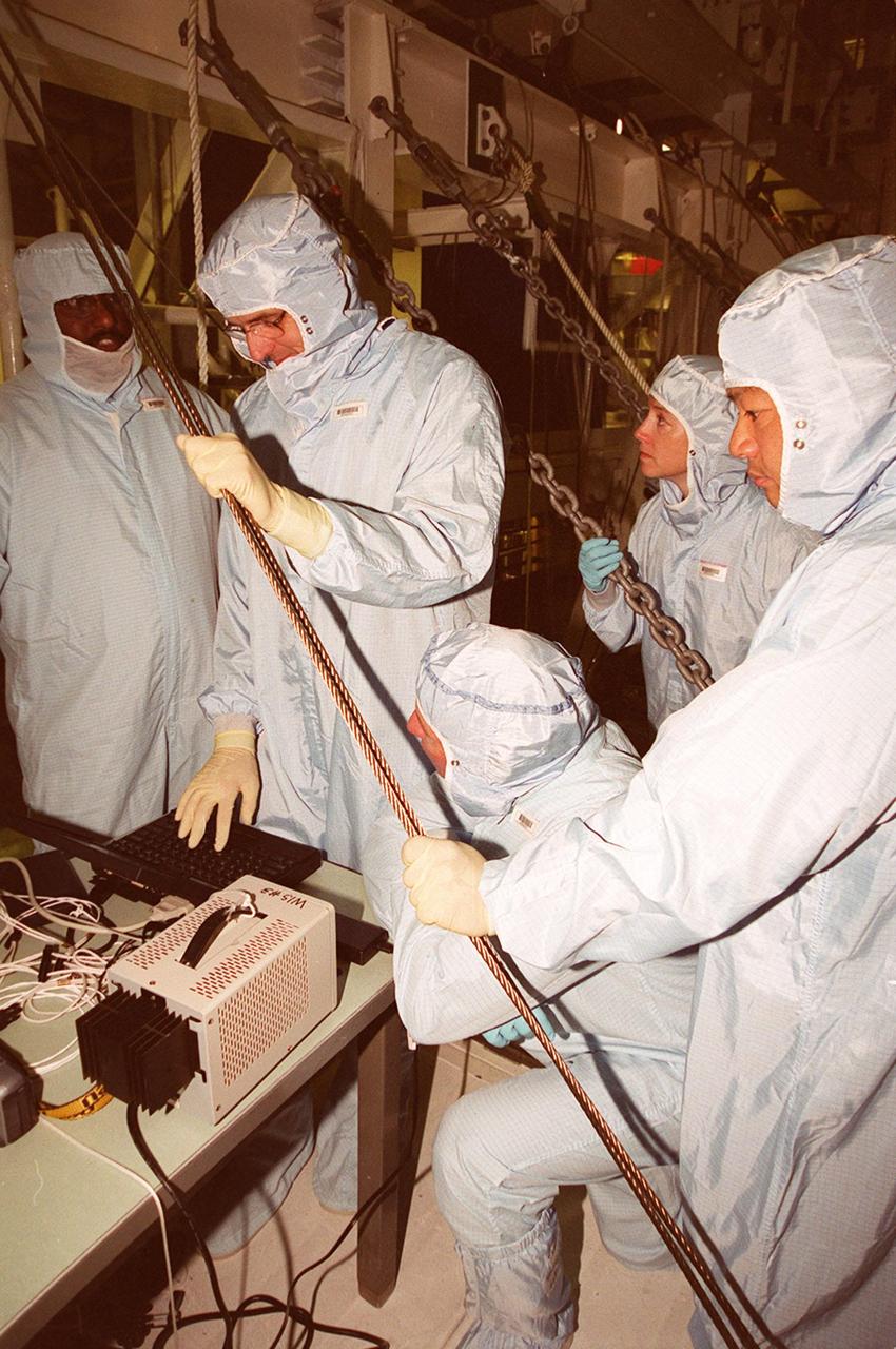 KENNEDY SPACE CENTER, FLA. -- In the Orbiter Processing Facility bay 1, members of the STS-92 crew examine equipment that will be part of their mission to the International Space Station (ISS). The fourth U.S. flight to the ISS, the mission payload includes the Integrated Truss Structure Z1, an early exterior framework to allow the first U.S. solar arrays on a future flight to be temporarily installed on Unity for early power; Ku-band communication to support early science capability and U.S. television; and PMA-3 to provide a Shuttle docking port for solar array installation on the sixth ISS flight and Lab installation on the seventh ISS flight. The crew comprises Mission Commander Brian Duffy, Pilot Pamela Melroy, and Mission Specialists Koichi Wakata, Leroy Chiao, Peter "Jeff" Wisoff, Michael Lopez-Alegria, and William McArthur. Launch of STS-92 is scheduled for Sept. 21, 2000. Wakata is with the National Space Development Agency of Japan