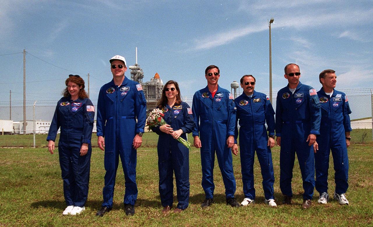 KENNEDY SPACE CENTER, FLA. -- The STS-101 crew gather during a meeting with family and friends at Launch Pad 39A. From left, Mission Specialist Susan J. Helms, Commander James D. Halsell Jr., Mission Specialist Mary Ellen Weber, Pilot Scott J. Horowitz and Mission Specialists Yuri Vladimirovich Usachev, Jeffery N. Williams and James S. Voss. In the background is the Space Shuttle Atlantis on the pad. Mission STS-101 will take the crew to the International Space Station to deliver logistics and supplies, plus prepare the Station for the arrival of the Zvezda Service Module, expected to be launched by Russia in July 2000. The crew will conduct one space walk to perform maintenance on the Space Station as well. This will be the third assembly flight for the Space Station. Launch is targeted for April 24 at about 4:15 p.m. EDT from Launch Pad 39A