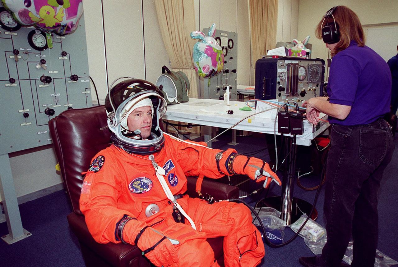 In the Operations and Checkout Building, STS-101 Mission Specialist Jeffrey N. Williams gets final check on his launch and entry suit before heading a second time to Launch Pad 39A and launch of Space Shuttle Atlantis. The previous day's launch attempt was scrubbed due to high cross winds at the Shuttle Landing Facility. The mission will take the crew to the International Space Station to deliver logistics and supplies and to prepare the Station for the arrival of the Zvezda Service Module, expected to be launched by Russia in July 2000. Also, the crew will conduct one space walk. This will be the third assembly flight to the Space Station. Liftoff is targeted for 3:52 p.m. EDT. The mission is expected to last about 10 days, with Atlantis landing at KSC Saturday, May 6, about 11:53 a.m. EDT