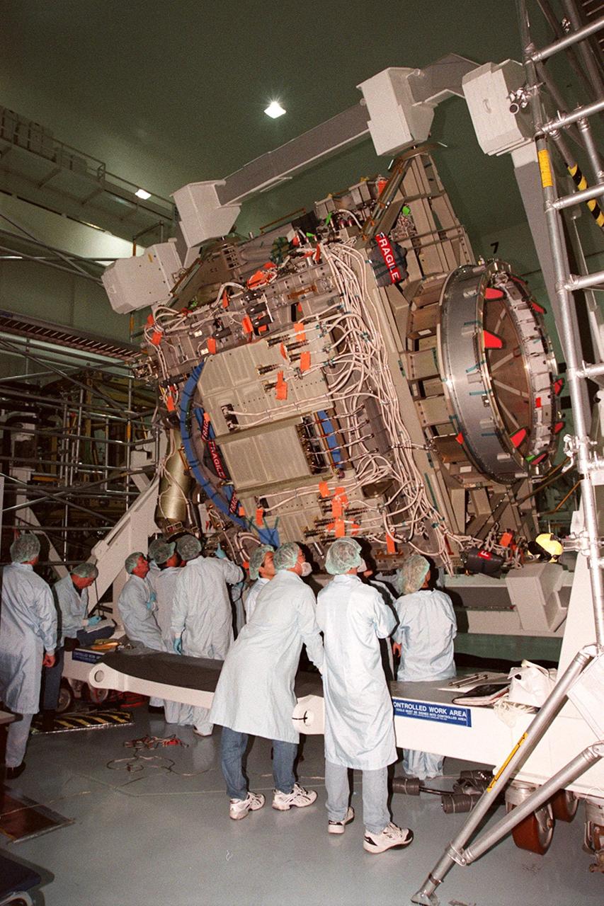 KENNEDY SPACE CENTER, FLA. -- In the Space Station Processing Facility, members of the STS-92 crew get a close look at the Integrated Truss Structure Z1, part of the payload on their mission. STS-92 is the fifth U.S. flight in the construction of the International Space Station. The crew comprises Mission Commander Brian Duffy, Pilot Pamela A. Melroy, and Mission Specialists Koichi Wakata, Leroy Chiao, Peter J.K. Wisoff, Michael E. Lopez-Alegria, and William S. McArthur Jr. Wakata is with the National Space Development Agency of Japan. The Z1 is an early exterior framework to allow the first U.S. solar arrays on a future flight to be temporarily installed on Unity for early power. Another part of the payload is a pressurized mating adapter, PMA-3, to provide a Shuttle docking port for solar array installation on the sixth ISS flight and Lab installation on the seventh ISS flight. Launch of STS-92 is scheduled for Sept. 21, 2000
