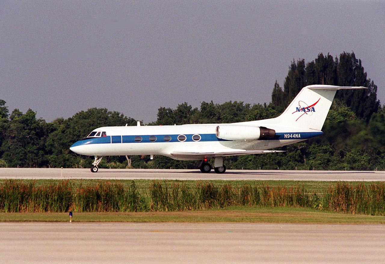 A Shuttle Training Aircraft (STA) taxis down the runway at KSC's Shuttle Landing Facility. The STA is a modified Grumman American Aviation-built Gulfstream II executive jet that was modified to simulate an orbiter's cockpit, motion and visual cues, and handling qualities. It is used by Shuttle flight crews to practice landing the orbiter. In flight, the STA duplicates the orbiter's atmospheric descent trajectory from approximately 35,000 feet altitude to landing on a runway. The orbiter differs in at least one major aspect from conventional aircraft; it is unpowered during re-entry and landing so its high-speed glide must be perfectly executed the first time there is no go-around capability. The orbiter touchdown speed is 213 to 226 miles (343 to 364 kilometers) per hour. There are two STAs, based in Houston