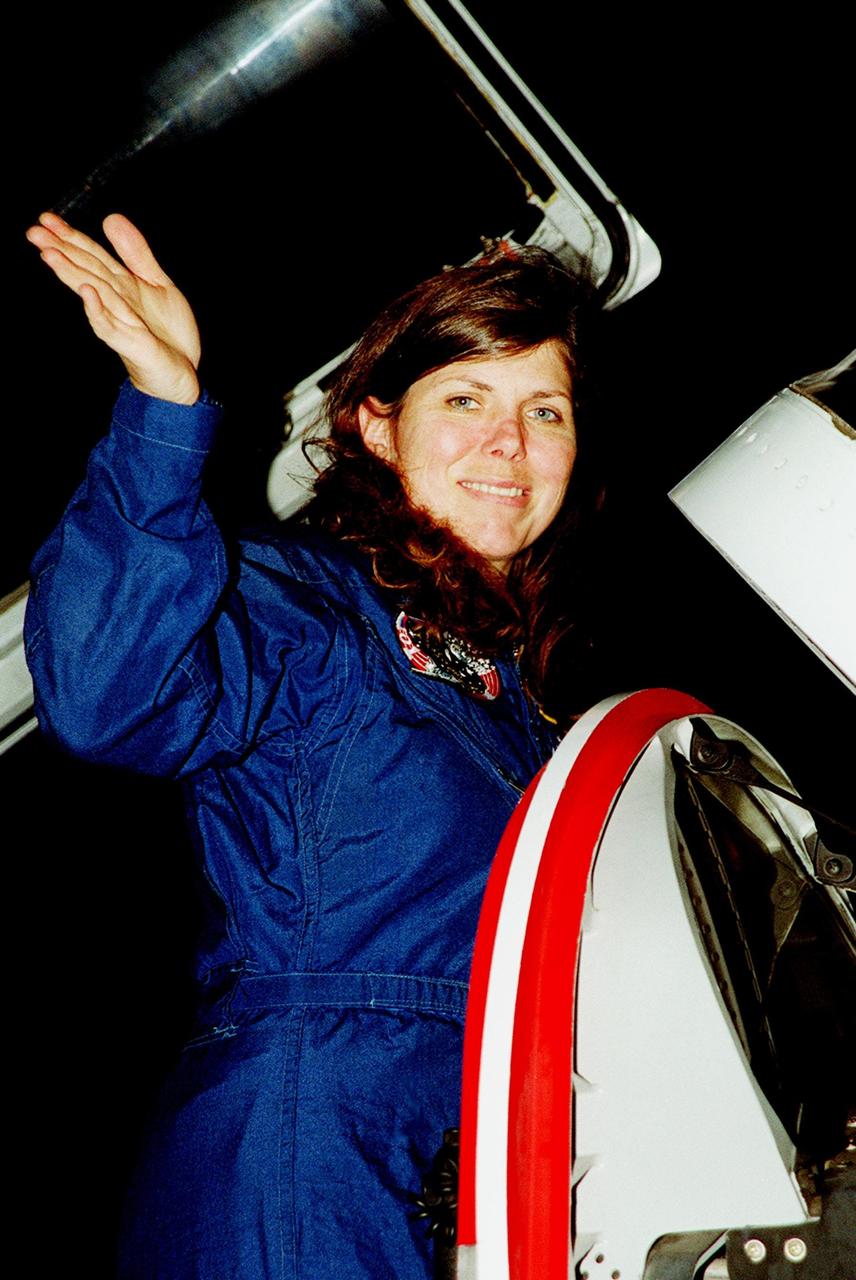 KENNEDY SPACE CENTER, FLA. -- STS-101 Mission Specialist Mary Ellen Weber waves before climbing out of a T-38 jet aircraft at KSC's Shuttle Landing Facility. She and the rest of the crew will be preparing for the launch on May 18. The mission will take the crew of seven to the International Space Station, delivering logistics and supplies, plus preparing the Station for the arrival of the Zvezda Service Module, expected to be launched by Russia in July 2000. Also, the crew will conduct one space walk to perform maintenance on the Space Station. This will be the third assembly flight for the Space Station. STS-101 is targeted for liftoff at 6:38 a.m. EDT from Launch Pad 39A