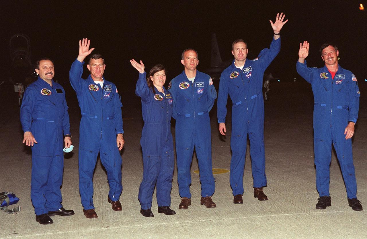 KENNEDY SPACE CENTER, FLA. -- Members of the STS-101 crew wave at media and photographers at KSC's Shuttle Landing Facility after their landing the night of May 14. Standing left to right are Mission Specialists Yuri Usachev, James Voss, Mary Ellen Weber and Jeff Williams; Commander James Halsell; and Pilot Scott Horowitz. Not present is Mission Specialist Susan Helms, who arrived later. The crew will be preparing for the launch on May 18. The mission will take the crew of seven to the International Space Station, delivering logistics and supplies, plus preparing the Station for the arrival of the Zvezda Service Module, expected to be launched by Russia in July 2000. Also, the crew will conduct one space walk to perform maintenance on the Space Station. This will be the third assembly flight for the Space Station. STS-101 is targeted for liftoff at 6:38 a.m. EDT from Launch Pad 39A
