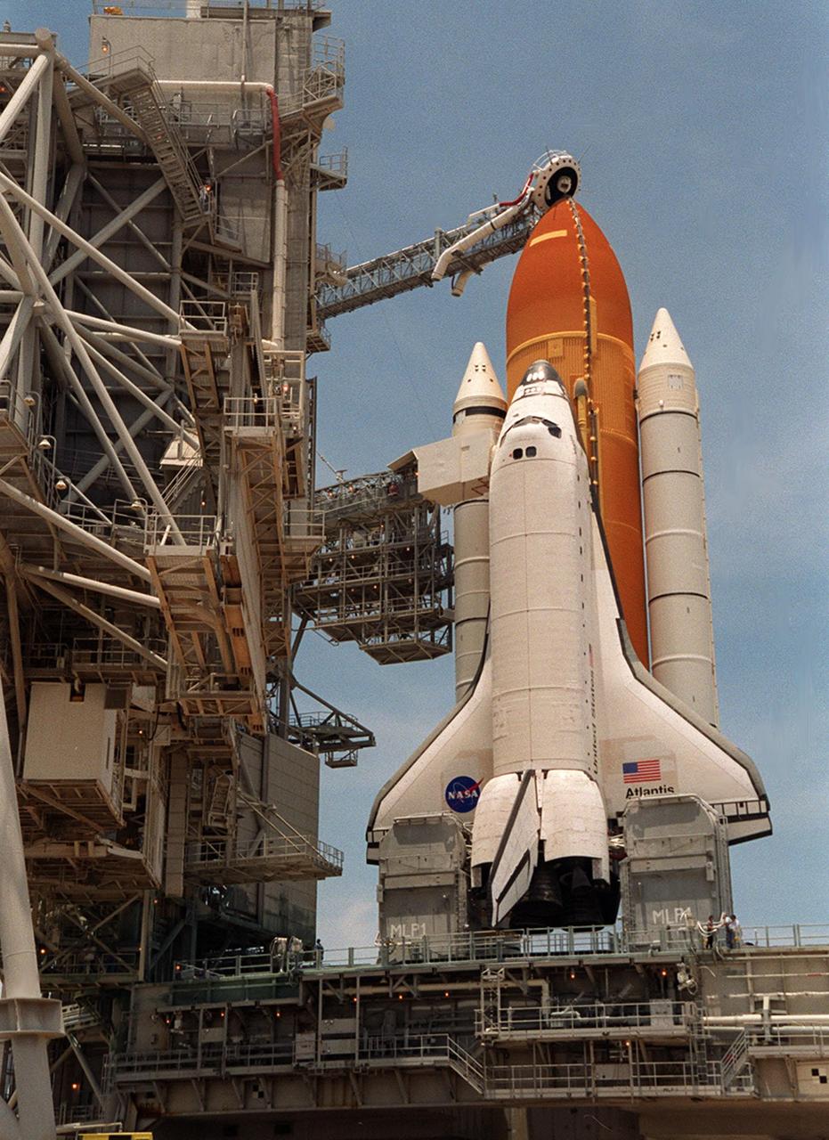 KENNEDY SPACE CENTER, Fla. -- After rollback of the Rotating Service Structure at Launch Pad 39A, Space Shuttle Atlantis awaits a fourth launch attempt on mission STS-101. At the top of the orange external tank can be seen the Gaseous Oxygen Vent Hood, often called the "beanie cap." The hood helps vent gaseous oxygen vapors away from the Space Shuttle. The hood will be raised and retracted two and a half minutes before launch. Abutting the side of Atlantis is the orbiter access arm with the environmental chamber known as the White Room at the end. The White Room provides access to the crew compartment. This will be the third assembly flight to the International Space Station. Liftoff of Space Shuttle Atlantis for the 10-day mission is scheduled for about 6:12 a.m. EDT from Launch Pad 39A. Landing is targeted for May 29 at 2:19 a.m. EDT. This is the 98th Shuttle flight and the 21st flight for Shuttle Atlantis