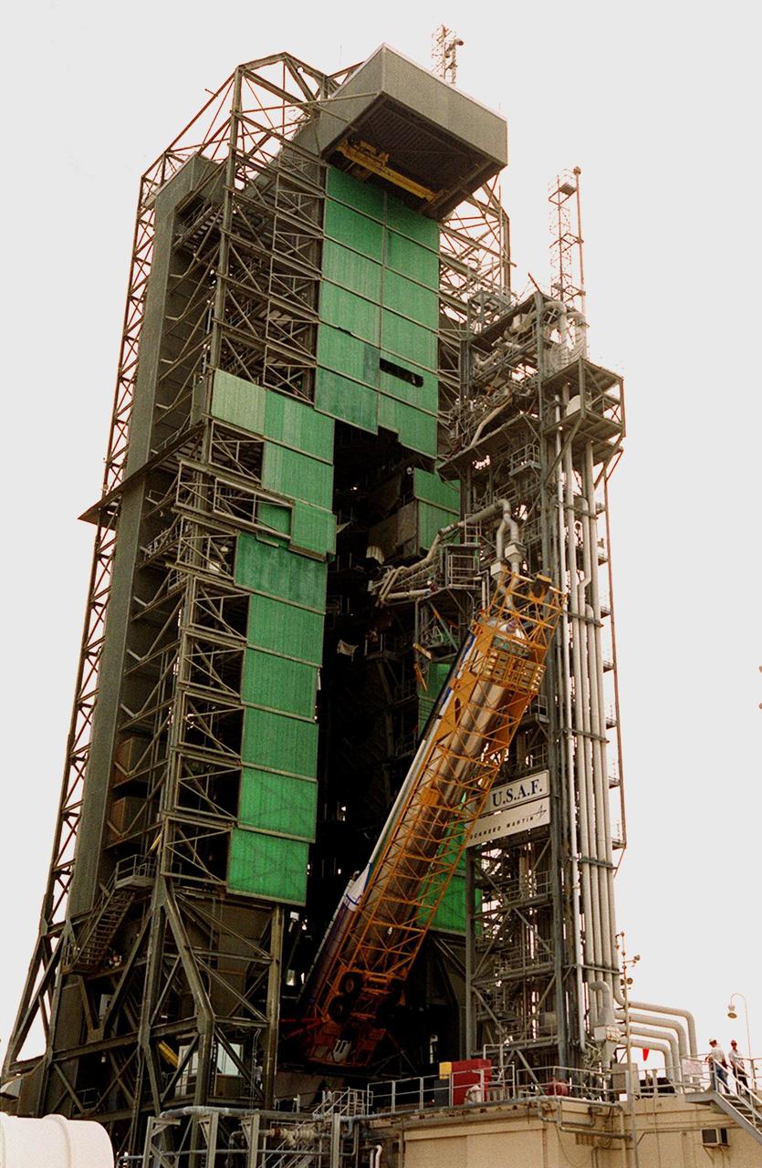At Launch Pad 36A, Cape Canaveral Air Force Station (CCAFS), the Atlas IIA rocket is halfway to a vertical position at the launch tower where it will be mated with the Centaur upper stage. The Atlas IIA/Centaur will launch the latest Tracking and Data Relay Satellite (TDRS) June 29 from CCAFS. The Atlas/Centaur launch vehicle is manufactured and operated by Lockheed Martin. Atlas IIA is capable of lifting payload systems weights in the 2,850 kg (6,300 lb) to 3,070 kg (6,760 lb) class to geosynchronous transfer orbit. It is 25 m (82 ft) long and 3.05 m (10 ft) in diameter. The Centaur is 10.0 m (33-ft) long and 3.05 m (10 ft) in diameter
