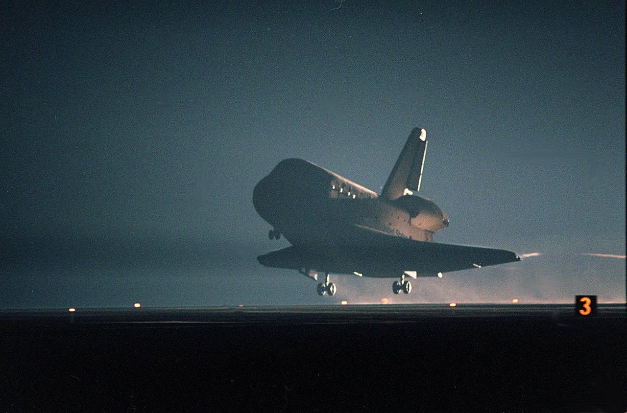 KENNEDY SPACE CENTER, Fla. -- Seen in the landing lights, an illuminated Space Shuttle Atlantis approaches touchdown on KSC’s Shuttle Landing Facility Runway 15 to complete the 9-day, 20-hour, 9-minute-long STS-101 mission. At the controls are Commander James D. Halsell Jr. and Pilot Scott “Doc” Horowitz. Also onboard the orbiter are Mission Specialists Mary Ellen Weber, James S. Voss, Jeffrey N. Williams, Susan J. Helms and Yury Usachev of Russia. The crew is returning from the third flight to the International Space Station. This was the 98th flight in the Space Shuttle program and the 21st for Atlantis, also marking the 51st landing at KSC, the 22nd consecutive landing at KSC, the 14th nighttime landing in Shuttle history and the 29th in the last 30 Shuttle flights. Main gear touchdown was at 2:20:17 a.m. EDT May 29 , landing on orbit 155 of the mission. Nose gear touchdown was at 2:20:30 a.m. EDT, and wheel stop at 2:21:19 a.m. EDT