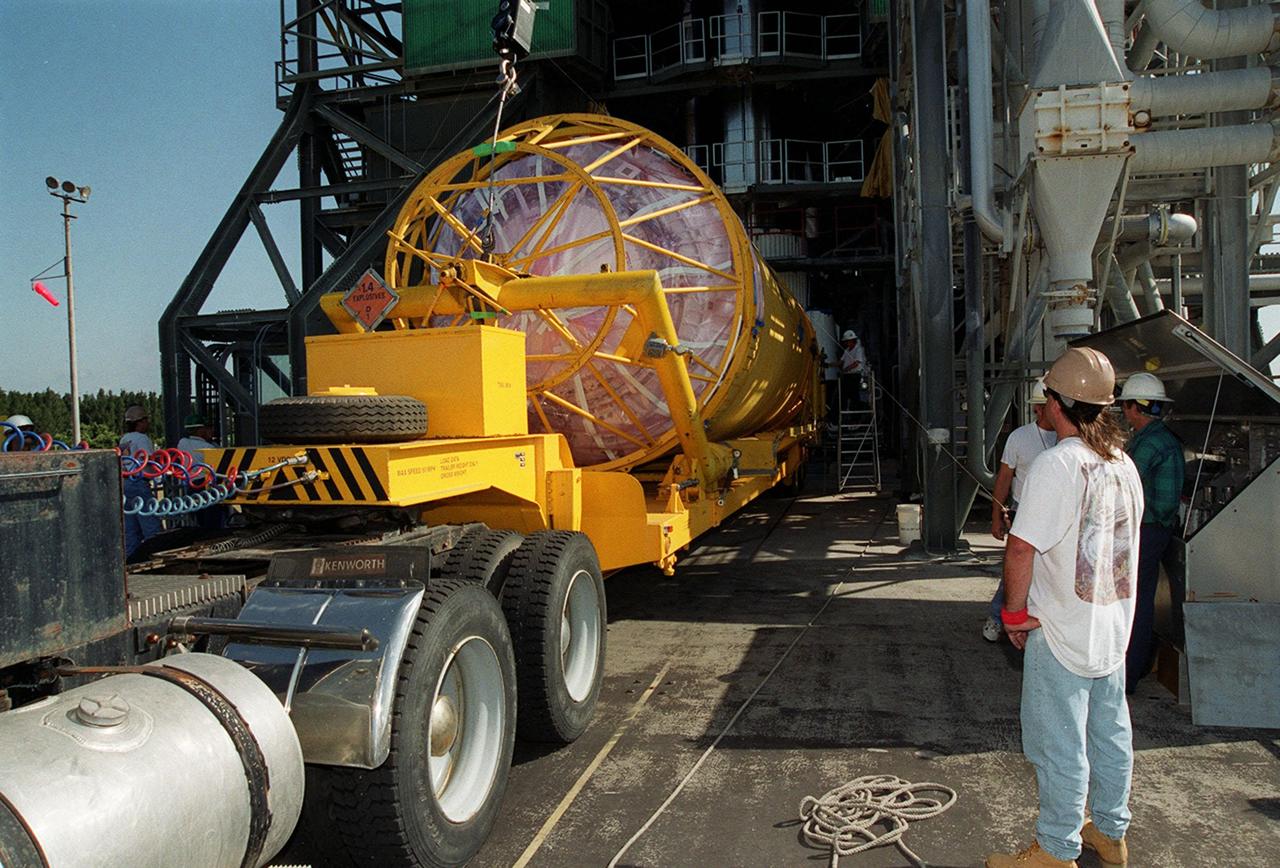 At Launch Pad 36A, Cape Canaveral Air Force Station, a Centaur rocket arrives for mating with the Atlas IIA rocket already in the tower. The Centaur upper stage is 10.0 m (33-ft) long and 3.05 m (10 ft) in diameter. The Lockheed-built Atlas IIA/Centaur rocket will launch the latest Tracking and Data Relay Satellite (TDRS) June 29 from CCAFS. The TDRS is one of three (labeled H, I and J) being built in the Hughes Space and Communications Company Integrated Satellite Factory in El Segundo, Calif. The new satellites will augment the TDRS system’s existing Sand Ku-band frequencies by adding Ka-band capability. TDRS will serve as the sole means of continuous, high-data-rate communication with the space shuttle, with the International Space Station upon its completion, and with dozens of unmanned scientific satellites in low earth orbit