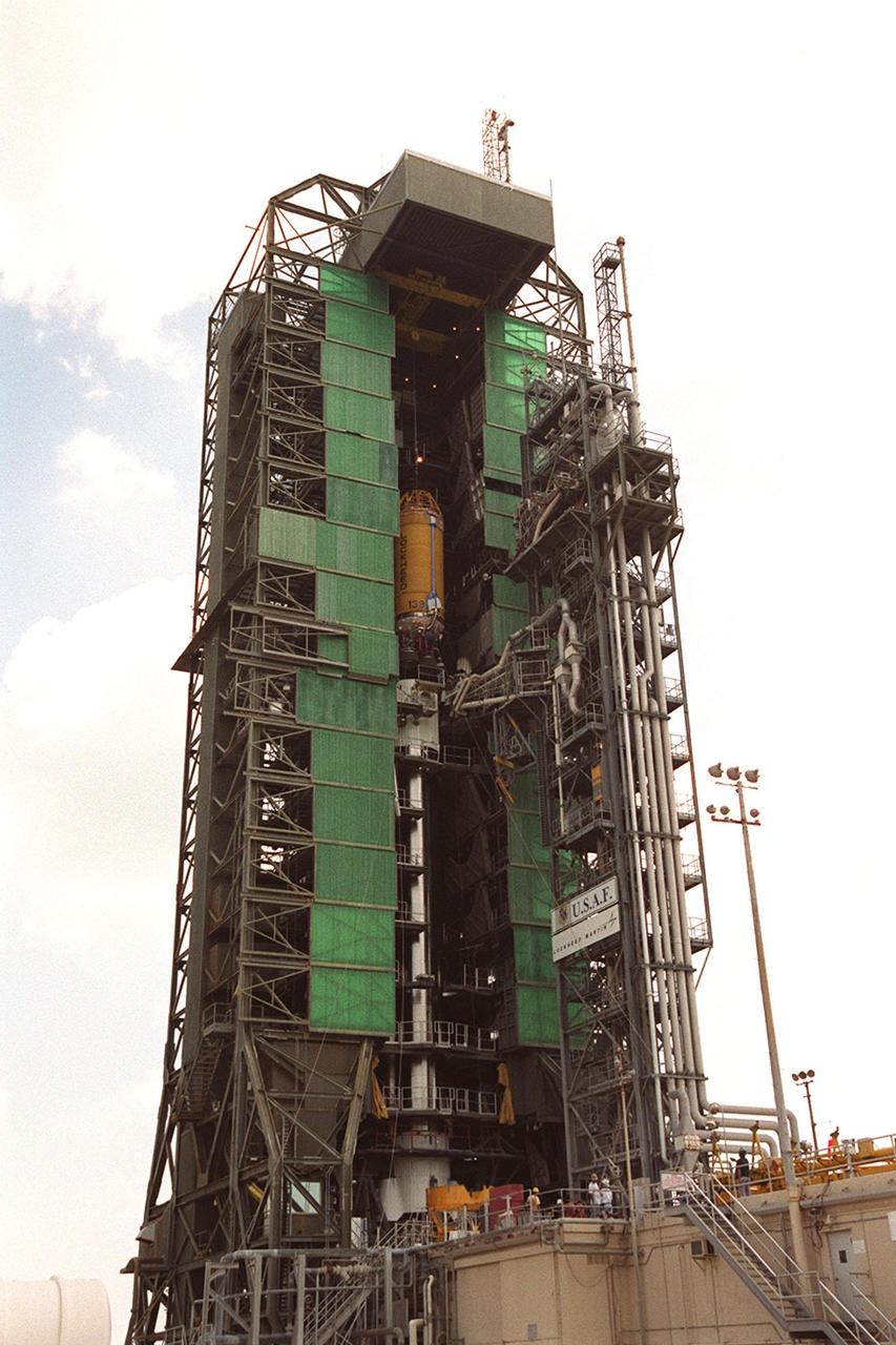 In this long view of the launch tower at Pad 36A, Cape Canaveral Air Force Station, the upper stage Centaur rocket can be seen as it rises up the tower to be mated to the lower stage Atlas IIA rocket already there. The Lockheed-built Atlas IIA/Centaur rocket will launch the latest Tracking and Data Relay Satellite (TDRS) June 29 from CCAFS. The TDRS is one of three (labeled H, I and J) being built in the Hughes Space and Communications Company Integrated Satellite Factory in El Segundo, Calif. The new satellites will augment the TDRS system’s existing Sand Ku-band frequencies by adding Ka-band capability. TDRS will serve as the sole means of continuous, high-data-rate communication with the space shuttle, with the International Space Station upon its completion, and with dozens of unmanned scientific satellites in low earth orbit