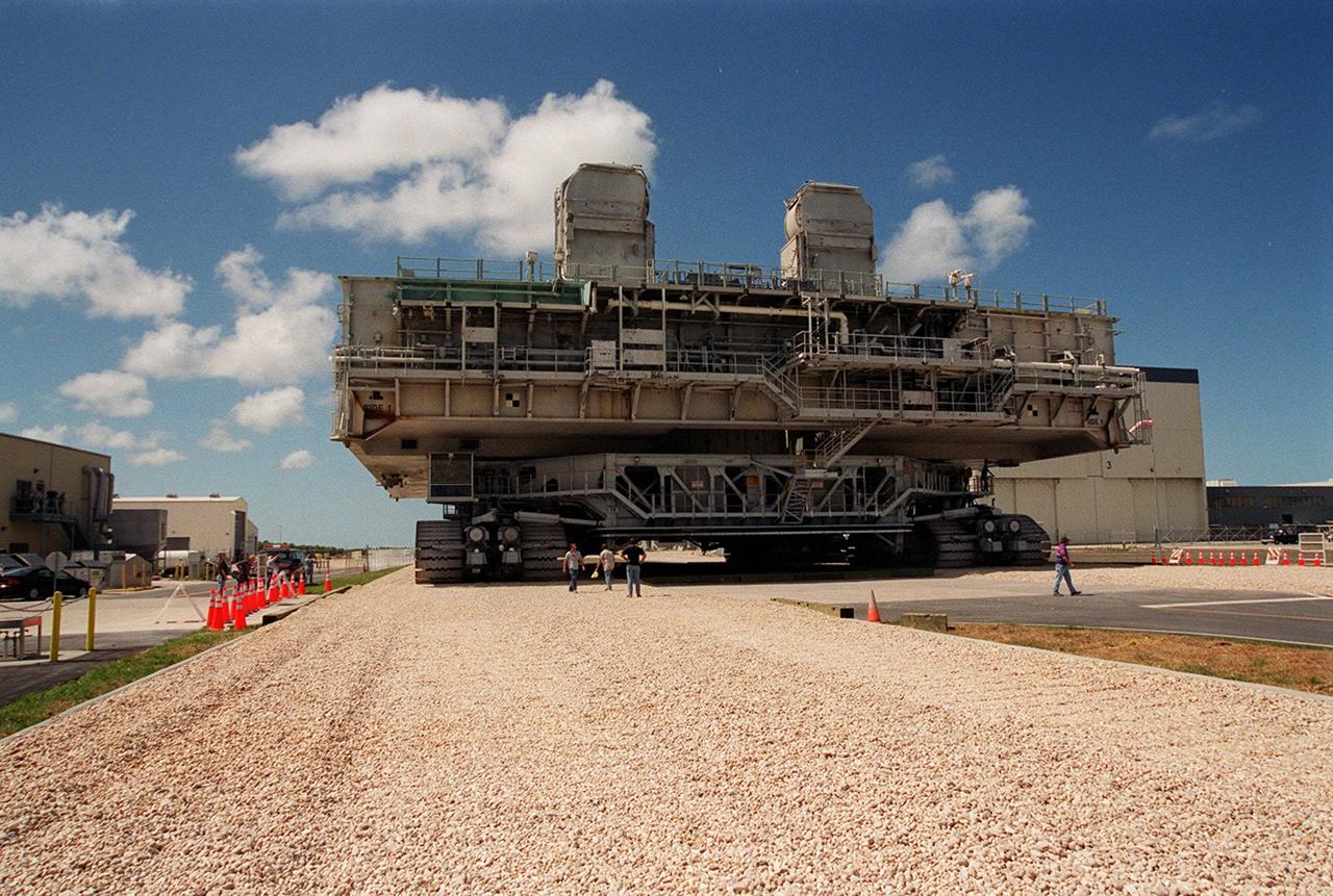 KENNEDY SPACE CENTER, FLA. -- A crawler-transporter with mobile launcher platform on top makes its way from the Orbiter Processing Facility along the once-buried portion of the Apollo-era crawlerway leading to the Vehicle Assembly Building (VAB) high bay. The road was restored as part of KSC’s Safe Haven project. High bay 2 provides a third stacking area.. The primary goal of the Safe Haven construction project was to strengthen readiness for hurricane season by expanding the VAB’s storage capacity. The new area, in high bay 2, will allow NASA to preassemble stacks and still have room in the VAB to pull a Shuttle back from the pad if severe weather threatens. Potential rollouts of the Space Shuttle to the launch pad from high bay 2 will involve making a turn around the north side of the VAB in contrast to the straight rollouts from high bays 1 and 3, on the east side of the VAB facing the launch pads