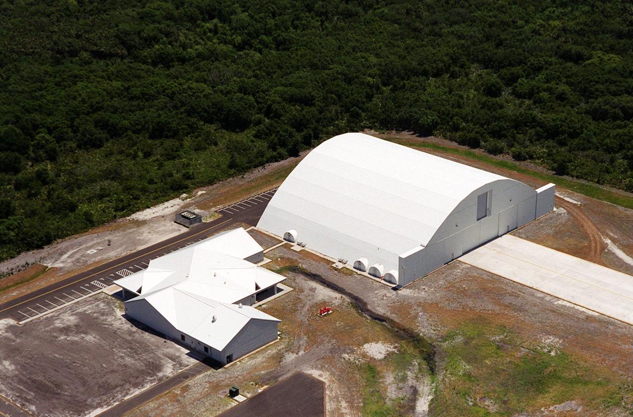 This closeup photo shows the Reusable Launch Vehicle (RLV) Support Complex at Kennedy Space Center. At right is a multi-purpose hangar and to the left is a building for related ground support equipment and administrative/ technical support. The complex is situated at the Shuttle Landing Facility. The RLV complex will be available to accommodate the Space Shuttle; the X-34 RLV technology demonstrator; the L-1011 carrier aircraft for Pegasus and X-34; and other RLV and X-vehicle programs. The complex is jointly funded by the Spaceport Florida Authority, NASA’s Space Shuttle Program and KSC