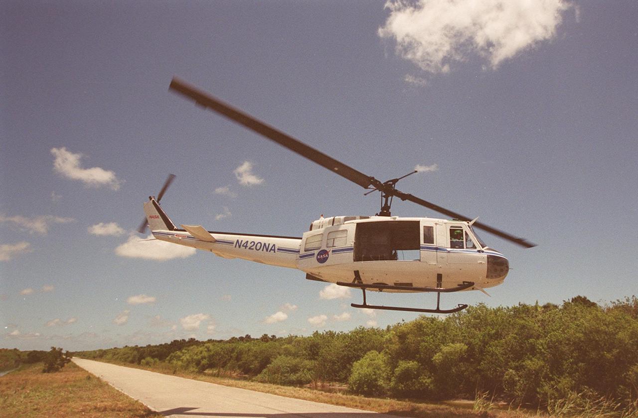 A NASA helicopter takes off to bring water to fight a small fire on Kennedy Space Center grounds. The site is between Kennedy Parkway North and the Indian River. The fire is one of many throughout Central Florida, which is suffering from drought