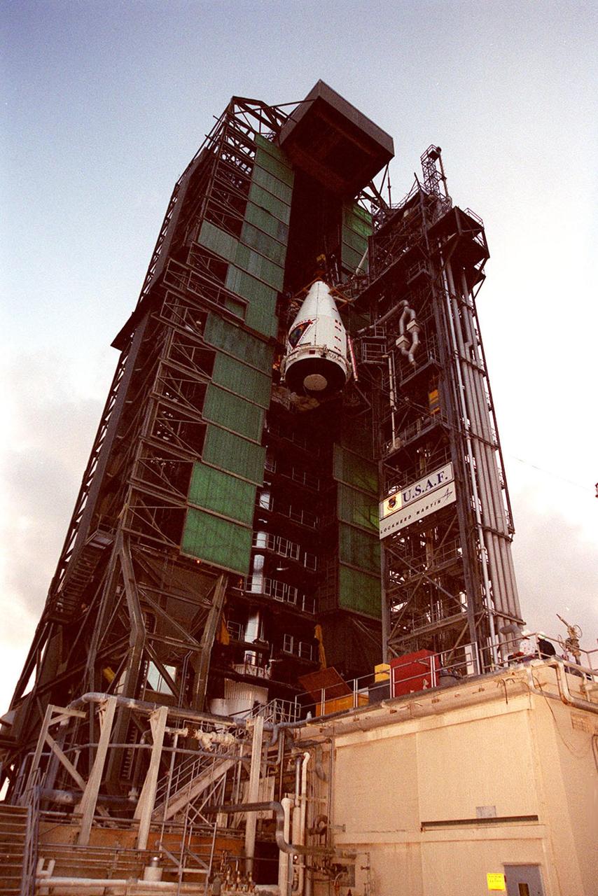 The nose fairing covering the Tracking and Data Relay Satellite (TDRS-H) nears the top of the launch tower at Launch Pad 36A, Cape Canaveral Air Force Station. It will be mated with the Atlas IIA/Centaur rocket, which is already stacked (barely visible behind the framework on lower left), for launch on June 29. The satellite will augment the TDRS system’s existing Sand Ku-band frequencies by adding Ka-band capability. TDRS will serve as the sole means of continuous, high-data-rate communication with the Space Shuttle, with the International Space Station upon its completion, and with dozens of unmanned scientific satellites in low earth orbit