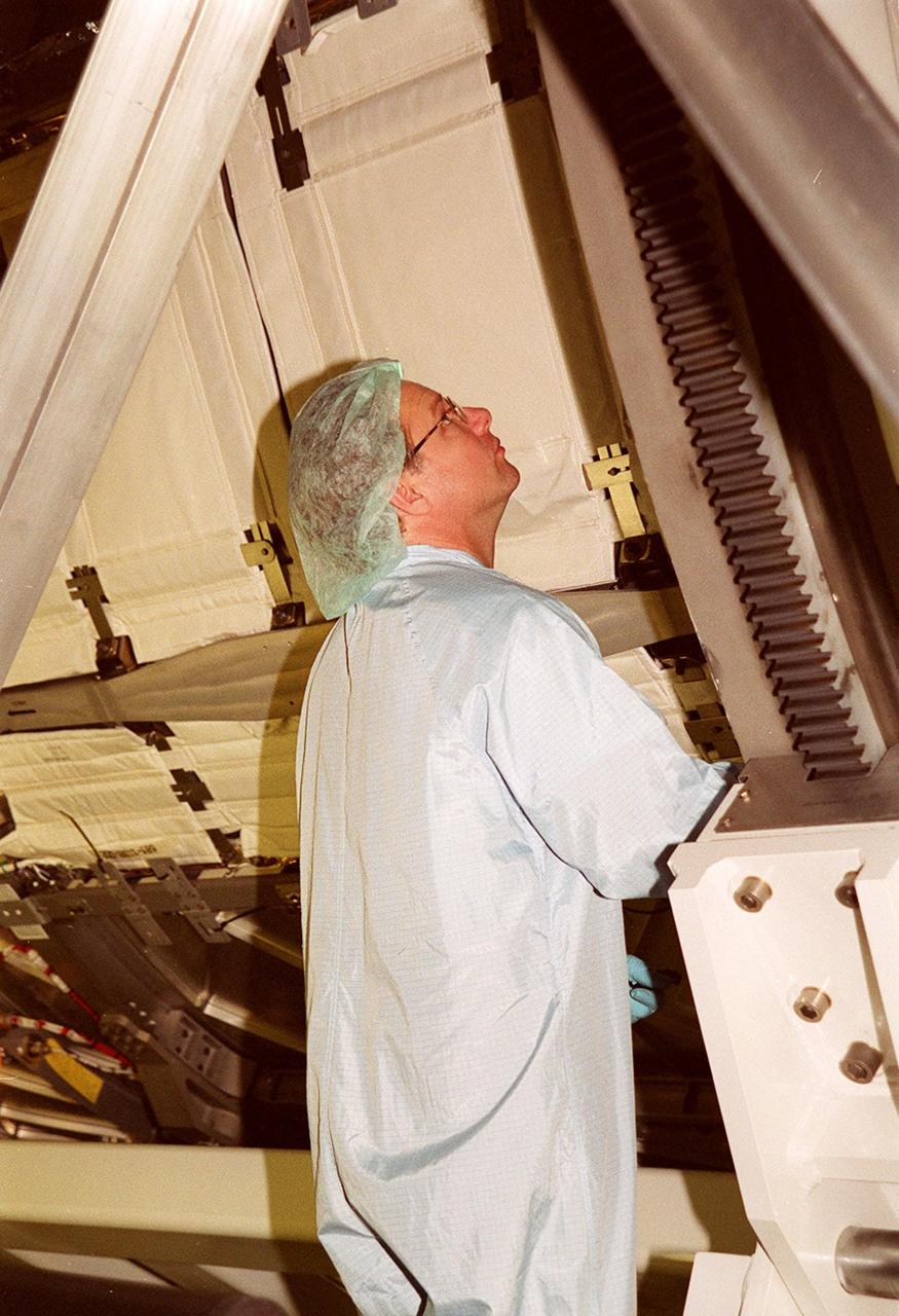 KENNEDY SPACE CENTER, FLA. -- In the Space Station Processing Facility, a worker checks the U.S. Laboratory Destiny as it rotates. A component of the International Space Station, Destiny is scheduled to fly on mission STS-98 in early 2001. During the mission, the crew will install the Lab during a series of three space walks. The STS-98 mission will provide the station with science research facilities and expand its power, life support and control capabilities. The U.S. Lab module continues a long tradition of microgravity materials research, first conducted by Skylab and later Shuttle and Spacelab missions. Destiny is expected to be a major feature in future research, providing facilities for biotechnology, fluid physics, combustion, and life sciences research