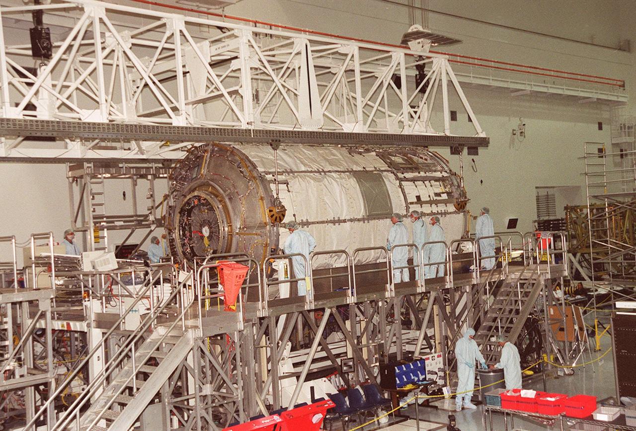 KENNEDY SPACE CENTER, Fla. -- In the Space Station Processing Facility, technicians watch closely as the U.S. Laboratory Destiny rotates. A component of the International Space Station, Destiny is scheduled to fly on mission STS-98 in early 2001. During the mission, the crew will install the Lab during a series of three space walks. The STS-98 mission will provide the station with science research facilities and expand its power, life support and control capabilities. The U.S. Lab module continues a long tradition of microgravity materials research, first conducted by Skylab and later Shuttle and Spacelab missions. Destiny is expected to be a major feature in future research, providing facilities for biotechnology, fluid physics, combustion, and life sciences research.    