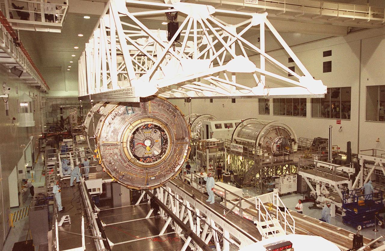 KENNEDY SPACE CENTER, FLA. -- The U.S. Laboratory Destiny, a component of the International Space Station, is lifted off a weigh stand (below) in the Space Station Processing Facility. The module is being moved to a payload canister for transfer to the Operations and Checkout Building where it will be tested in the altitude chamber. Destiny is scheduled to fly on mission STS-98 in early 2001. During the mission, the crew will install the Lab in the Space Station during a series of three space walks. The STS-98 mission will provide the Station with science research facilities and expand its power, life support and control capabilities. The U.S. Lab module continues a long tradition of microgravity materials research, first conducted by Skylab and later Shuttle and Spacelab missions. Destiny is expected to be a major feature in future research, providing facilities for biotechnology, fluid physics, combustion, and life sciences research