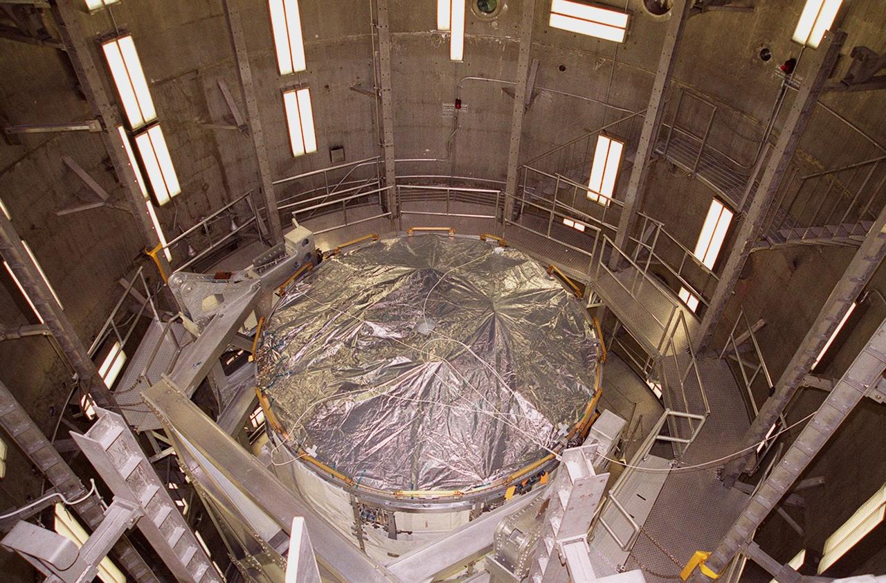 KENNEDY SPACE CENTER, FLA. -- The U.S. Lab, a component of the International Space Station, is lowered inside the three-story vacuum chamber in the Operations and Checkout Building. The 32,000-pound scientific research lab, named Destiny, is the first Space Station element to spend seven days in the renovated vacuum chamber for a leak test. Destiny is scheduled to be launched on Shuttle mission STS-98, the 5A assembly mission, targeted for Jan. 18, 2001. During the mission, the crew will install the Lab in the Space Station during a series of three space walks. The STS-98 mission will provide the Station with science research facilities and expand its power, life support and control capabilities. The U.S. Lab module continues a long tradition of microgravity materials research, first conducted by Skylab and later Shuttle and Spacelab missions. Destiny is expected to be a major feature in future research, providing facilities for biotechnology, fluid physics, combustion, and life sciences research
