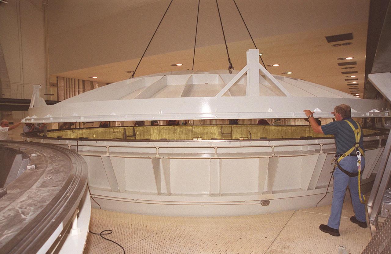 KENNEDY SPACE CENTER, FLA. -- A worker in the Operations and Checkout Building checks the placement of the lid on the vacuum chamber containing the U.S. Lab, a component of the International Space Station. The 32,000-pound scientific research lab, named Destiny, is the first Space Station element to spend seven days in the renovated vacuum chamber for a leak test. Destiny is scheduled to be launched on Shuttle mission STS-98, the 5A assembly mission, targeted for Jan. 18, 2001. During the mission, the crew will install the Lab in the Space Station during a series of three space walks. The STS-98 mission will provide the Station with science research facilities and expand its power, life support and control capabilities. The U.S. Lab module continues a long tradition of microgravity materials research, first conducted by Skylab and later Shuttle and Spacelab missions. Destiny is expected to be a major feature in future research, providing facilities for biotechnology, fluid physics, combustion, and life sciences research
