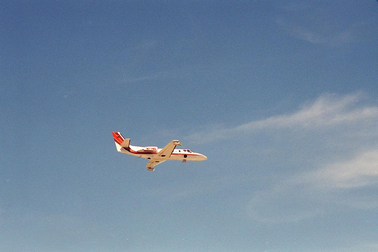 A specially equipped Cessna Citation aircraft flies over KSC during a calibration test of field mills used to measure electric fields. The aircraft is also equipped with cloud physics probes that measure the size, shape and number of ice and water particles in clouds. The plane is being flown into anvil clouds in the KSC area as part of a study to review and possibly modify lightning launch commit criteria. The weather study could lead to improved lightning avoidance rules and fewer launch scrubs for the Space Shuttle and other launch vehicles on the Eastern and Western ranges.; More information on this study can be found in <a href="http://www-pao.ksc.nasa.gov/kscpao/release/2000/56-00.htm">Release No. 56-00</a>