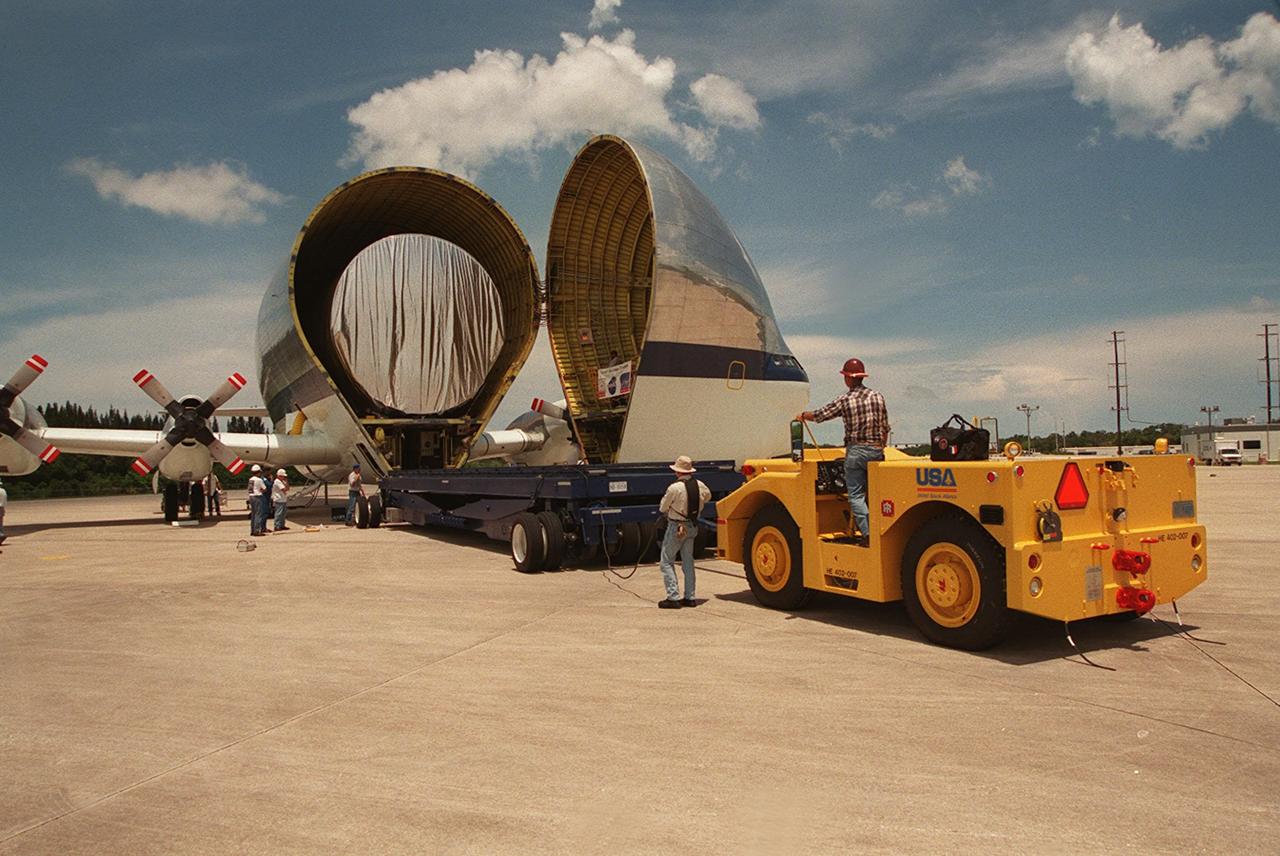 On July 26, 2000 the P-1 truss arrived at Kennedy Space Center’s Shuttle Landing Facility aboard its &quot;Super Guppy&quot; transport. A flatbed truck was backed up to begin the off loading of the P-1 truss in preparation for movement to the Operations and Checkout Building for processing. The P-1 truss, scheduled to fly in spring of 2002, is part of a total 10-truss, girder-like structure that will ultimately extend the length of a football field. Astronauts will attach the 14-by-15 foot structure to the port side of the center truss, SO, during the spring assembly flight. The 33,000-pound P-1 will house the thermal radiator rotating joint (TRRJ) that will rotate the International Space Station’s radiators away from the sun to increase their maximum cooling efficiency