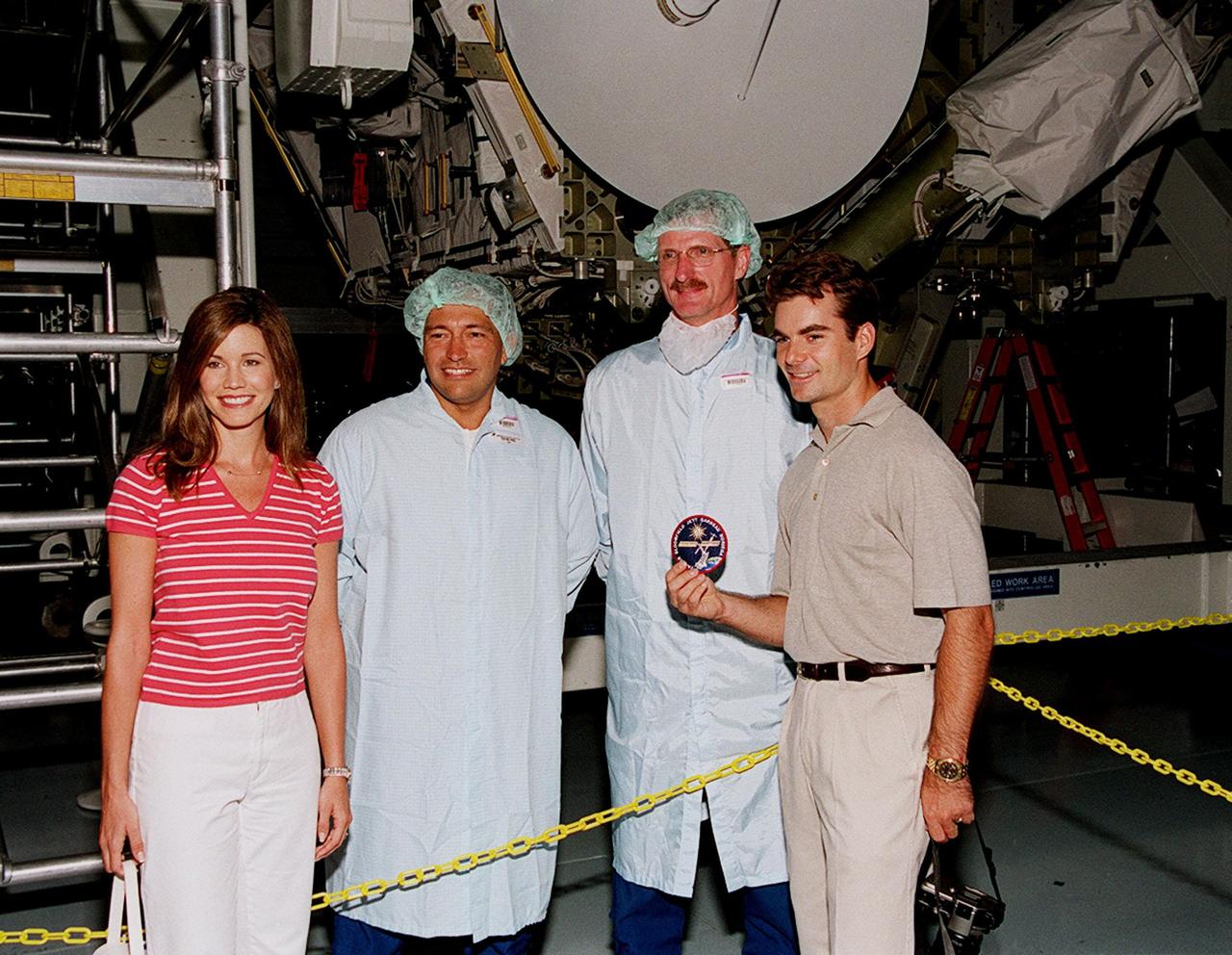 KENNEDY SPACE CENTER, FLA. -- During a visit to KSC, NASCAR race driver Jeff Gordon (far right) and his wife (far left) pose with astronauts Michael Lopez-Alegria (second from left) and Joe Tanner (third from left)