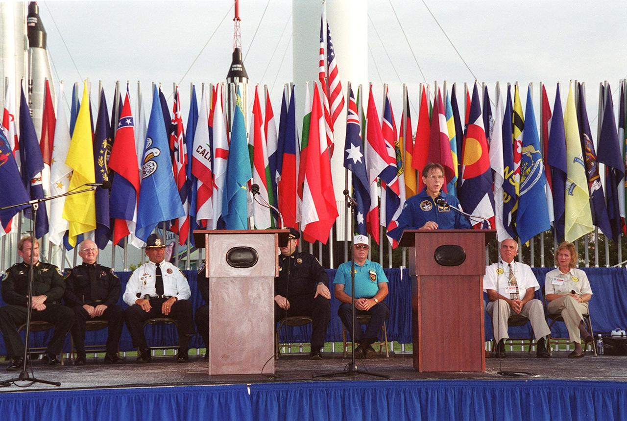 During opening ceremonies of the 2000 International Law Enforcement Games, astronaut Sam Durrance addresses an audience of 1,850 participants and their families. Held in the KSC Visitor Complex Rocket Garden, the ceremony included parades, torch lighting and a tug of war. The games feature officers from 15 countries and 37 United States in competitions around Brevard County, Fla
