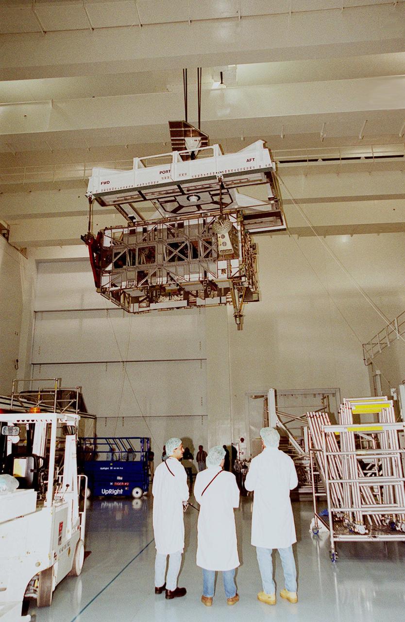KENNEDY SPACE CENTER, FLA. -- In the Space Station Processing Facility, an overhead crane moves the P4 truss to a workstand. Part of the 10-truss, girder-like structure that will ultimately extend the length of a football field on the International Space Station, the P4 is the second port truss segment that will attach to the first port truss segment (P1 truss). The P4 is scheduled for mission 12A in September 2002.