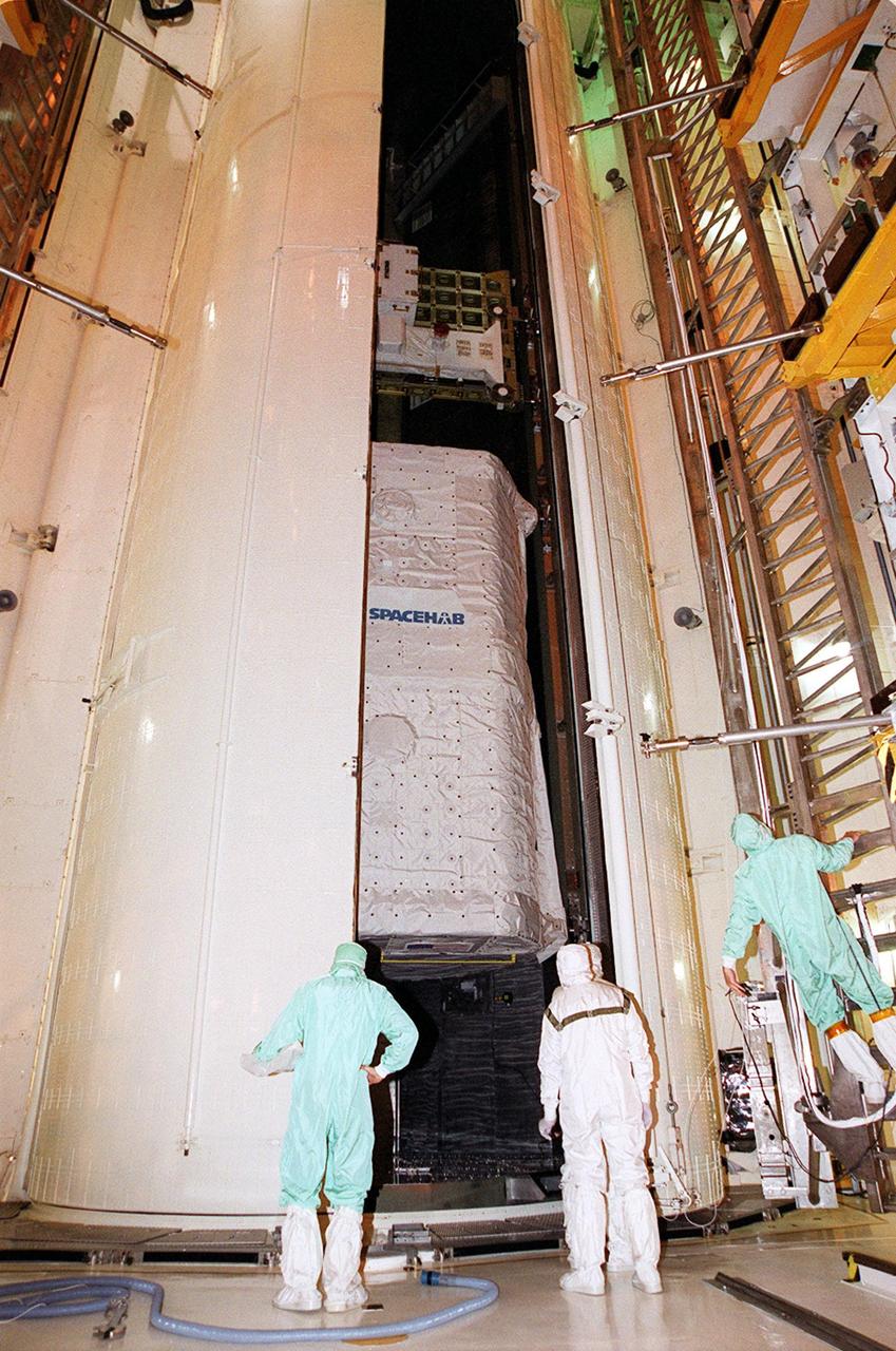 KENNEDY SPACE CENTER, FLA. -- In the Payload Changeout Room (part of the Rotating Service Structure at the launch pad), the doors of the payload canister open to reveal its cargo, the SPACEHAB module (bottom) and Integrated Cargo Carrier (top). The payload will be transferred from this environmentally controlled room into the payload bay of Shuttle Atlantis for mission STS-106. The 11-day mission to the International Space Station will include service module support tasks on orbit, transfer supplies and outfit the Space Station for the first long-duration crew. Atlantis is scheduled to launch Sept. 8 at 8:31 a.m. EDT