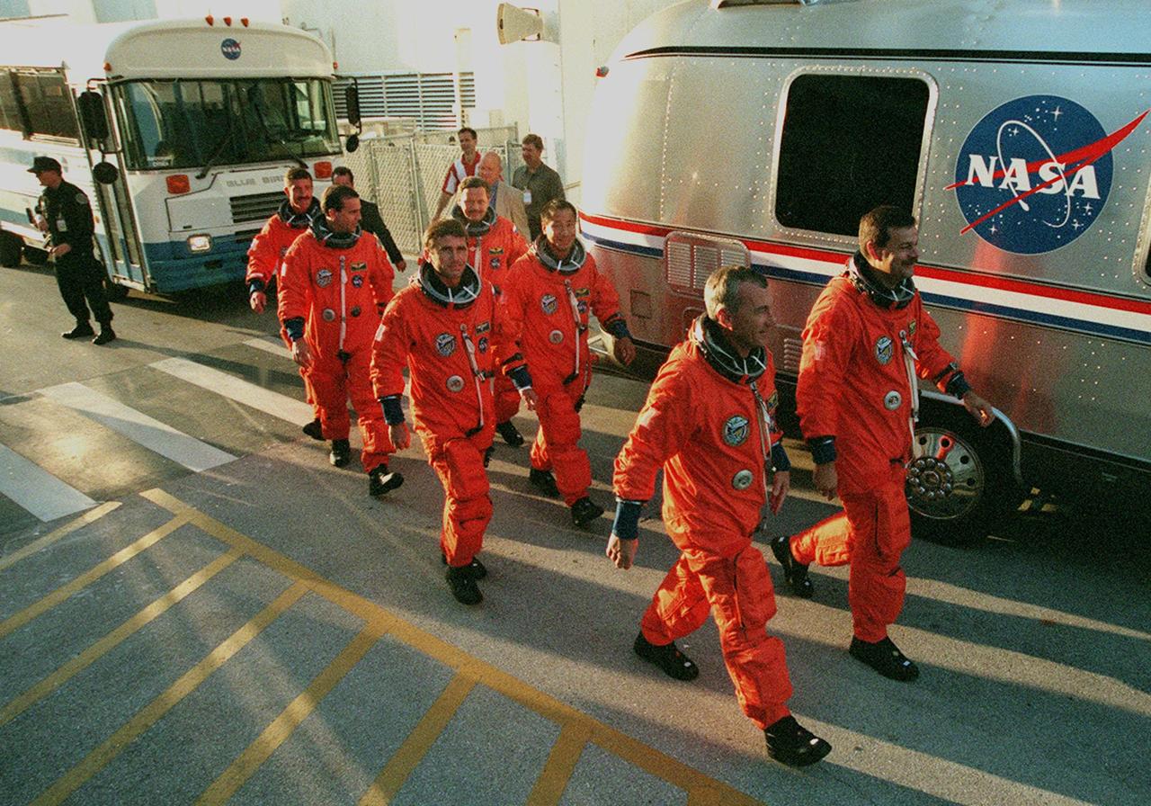 KENNEDY SPACE CENTER, Fla. -- The STS-106 flight crew departs the Operations & Checkout Facility to take part in Terminal Countdown Demonstration Test (TCDT) activities. The TCDT provides the crew with emergency egress training and opportunities to inspect their mission payload in the orbiter’s payload bay. Crew members taking part in the TCDT are, from left to right front to back, Commander Terrence W. Wilcutt, Pilot Scott D. Altman, Mission Specialists Yuri I. Malenchenko, Edward T. Lu, Richard A. Mastracchio, Boris V. Morukov and Daniel C. Burbank. Malenchenko and Morukov are with the Russian Aviation and Space Agency. STS-106 is scheduled to launch Sept. 8, 2000, at 8:31 a.m. EDT from Launch Pad 39B. On the 11-day mission, the seven-member crew will perform support tasks on orbit, transfer supplies and prepare the living quarters in the newly arrived Zvezda Service Module. The first long-duration crew, dubbed “Expedition One,” is due to arrive at the Station in late fall