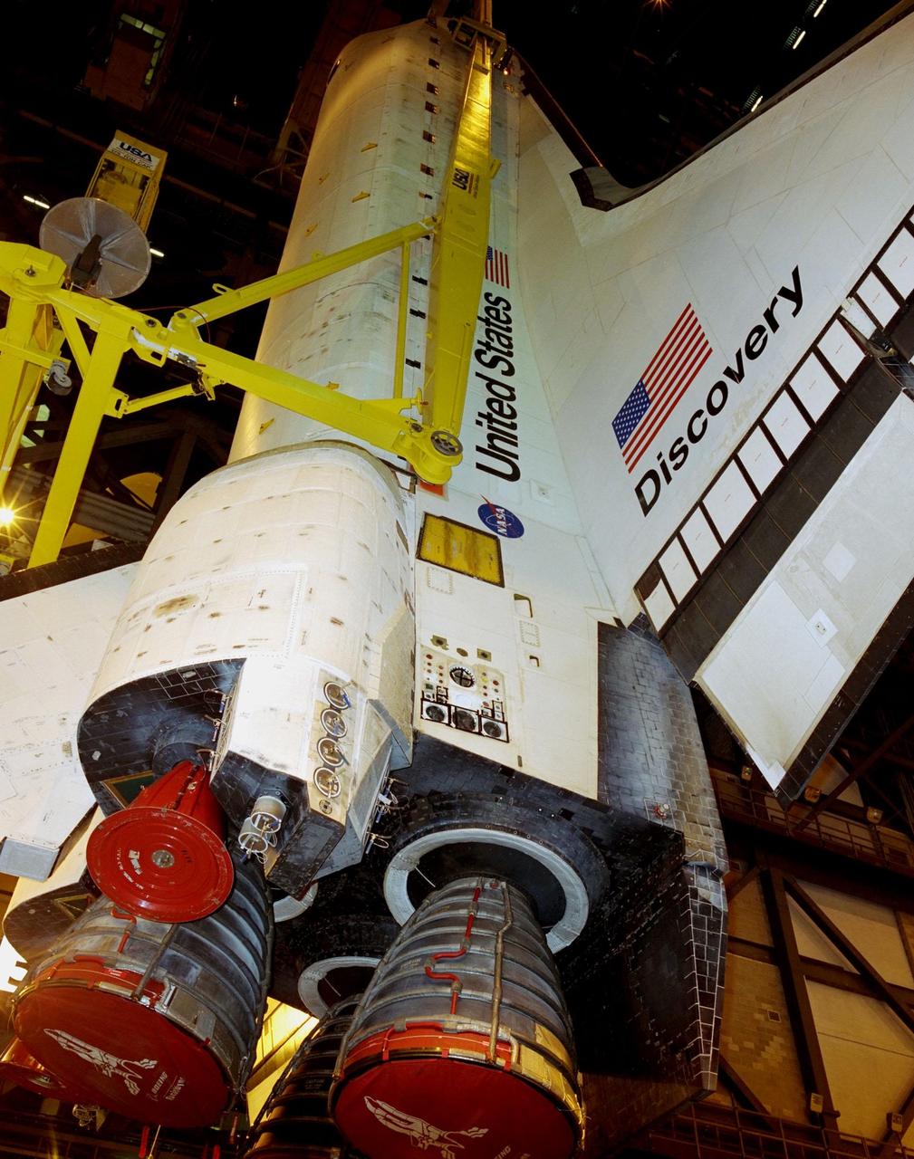 KENNEDY SPACE CENTER, FLA. -- The orbiter Discovery is viewed from below as it is lifted in the transfer aisle of the Vehicle Assembly Building. The orbiter will be transferred to high bay 3 to be mated to an external tank and solid rocket boosters. Discovery is scheduled to launch Oct. 5 at 9:30 p.m. EDT on mission STS-92, delivering two elements of the International Space Station: the Z-1 truss and Pressurized Mating Adapter-3. The launch will be the 100th flight in the Shuttle program