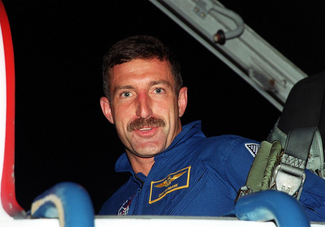 STS-106 Mission Specialist Daniel C. Burbank smiles on his arrival at the KSC Shuttle Landing Facility. He and the rest of the crew will be making pre-launch preparations for the fourth flight to the International Space Station. STS-106 is scheduled to launch Sept. 8, 2000, at 8:45 a.m. EDT from Launch Pad 39B. On the 11-day mission, the seven-member crew will perform support tasks on orbit, transfer supplies and prepare the living quarters in the newly arrived Zvezda Service Module. The first long-duration crew, dubbed “Expedition One,” is due to arrive at the Station in late fall