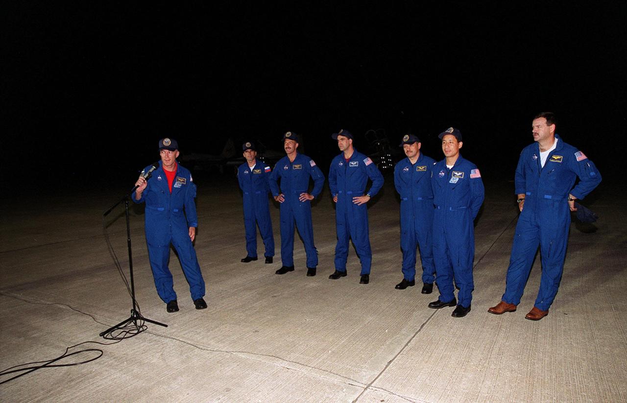 After their arrival at the KSC Shuttle Landing Facility, the STS-106 crew meet the media. Commander Terrence W. Wilcutt, at the microphone, says a few words; the rest of the crew waits behind him. From left, they are Mission Specialists Yuri I. Malenchenko, Daniel C. Burbank, Richard A. Mastracchio, Boris V. Morukov and Edward T. Lu; and Pilot Scott D. Altman. Malenchenko and Morukov are with the Russian Aviation and Space Agency. The crew will be making pre-launch preparations for the fourth flight to the International Space Station. STS-106 is scheduled to launch Sept. 8, 2000, at 8:45 a.m. EDT from Launch Pad 39B. On the 11-day mission, the seven-member crew will perform support tasks on orbit, transfer supplies and prepare the living quarters in the newly arrived Zvezda Service Module. The first long-duration crew, dubbed “Expedition One,” is due to arrive at the Station in late fall