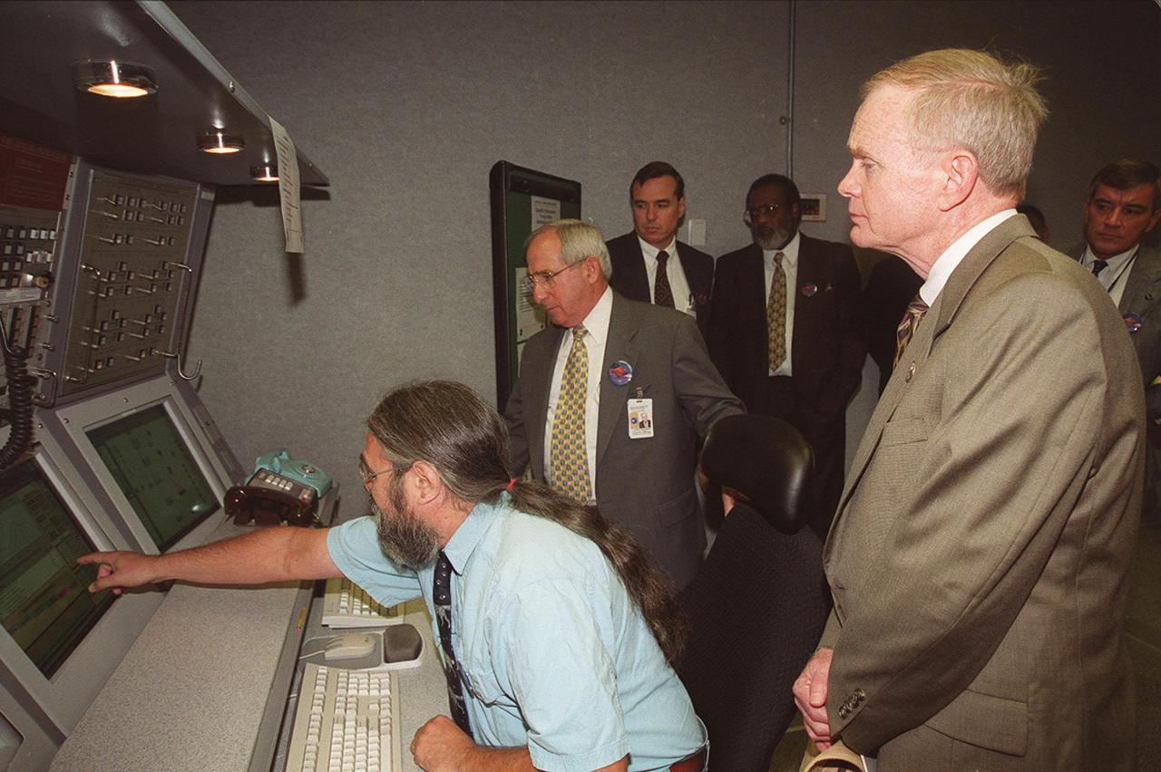 KSC Director Roy Bridges (right) views the new Checkout and Launch Control System (CLCS) at the Hypergolic Maintenance Facility (HMF). Looking on (left to right)are NASA Associate Administrator for Space Flight Joseph Rothenberg, United Space Alliance Lead IPT Frank Norris, KSC Deputy Center Director Jim Jennings, and Deputy Director of External Relations & Business Development Joe Gordon (behind Bridges). At the controls is Charles Novak, HMF programmer, United Space Alliance. The CLCS was declared operational in a ribbon cutting ceremony earlier. The new control room will be used to process the Orbital Maneuvering System pods and Forward Reaction Control System modules at the HMF. This hardware is removed from Space Shuttle orbiters and routinely taken to the HMF for checkout and servicing